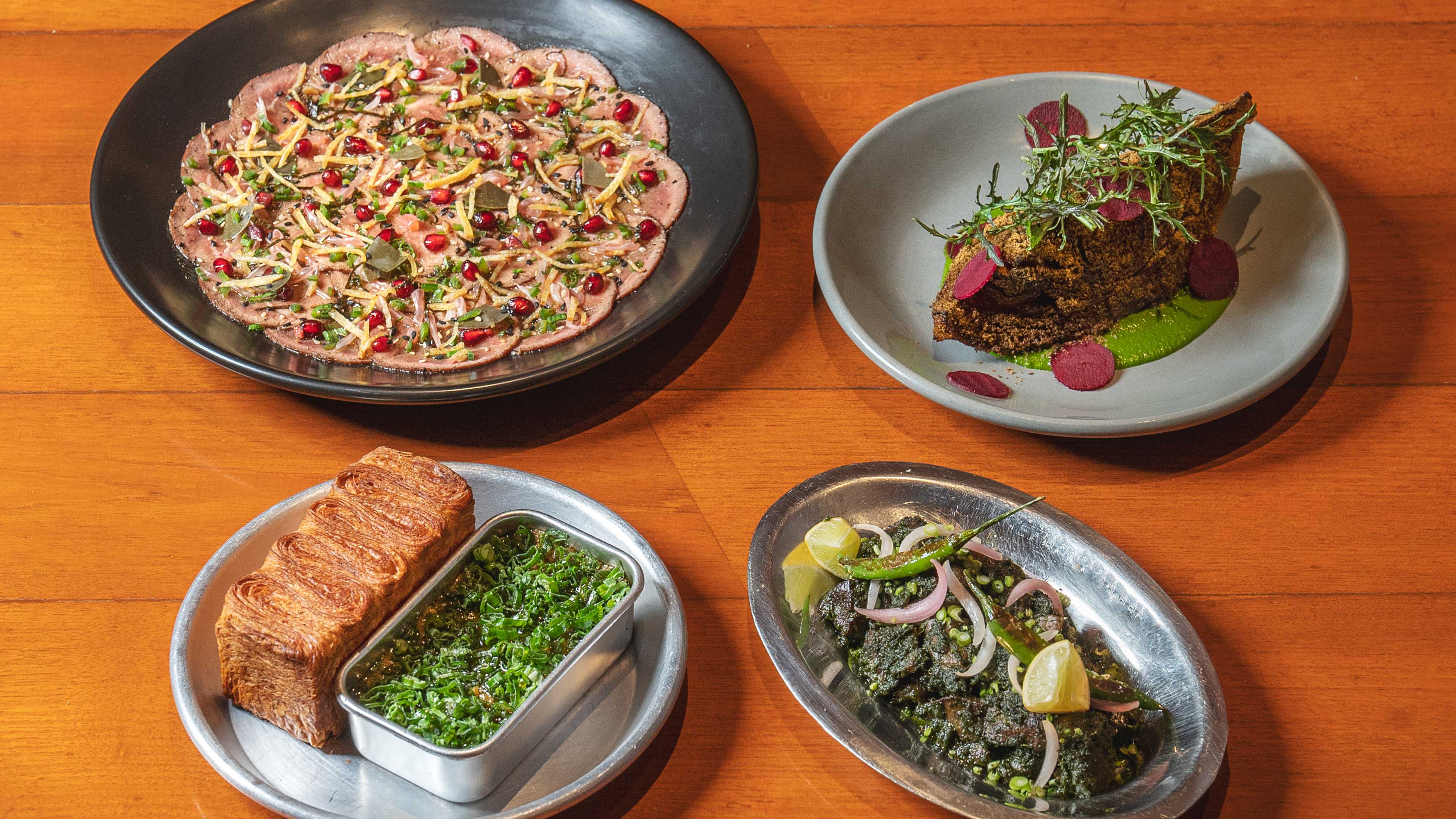 Spread of dishes on wooden table at Bandra Born