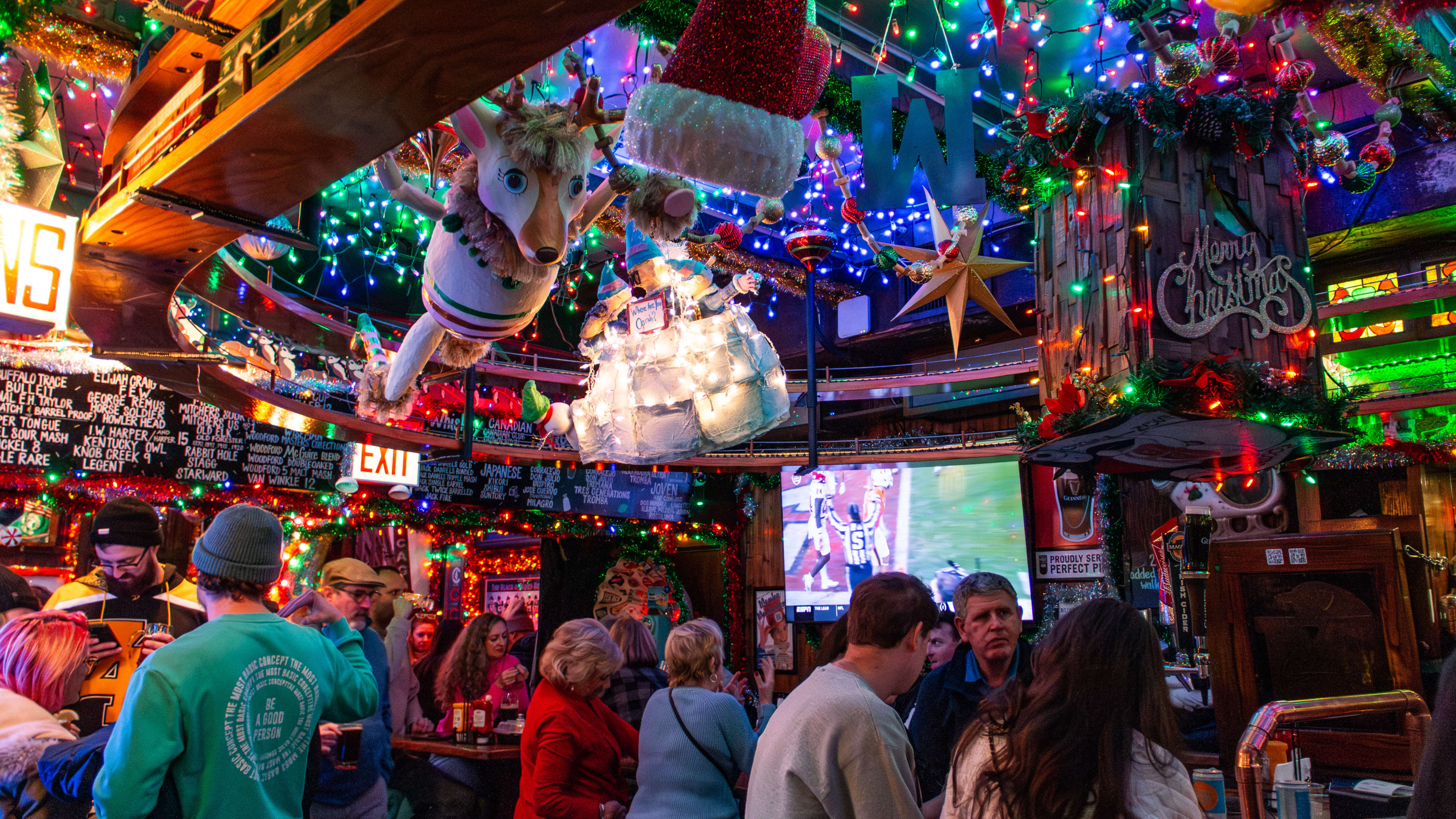 The interior of Butch McGuire’s covered in hanging holiday lights and decorations.