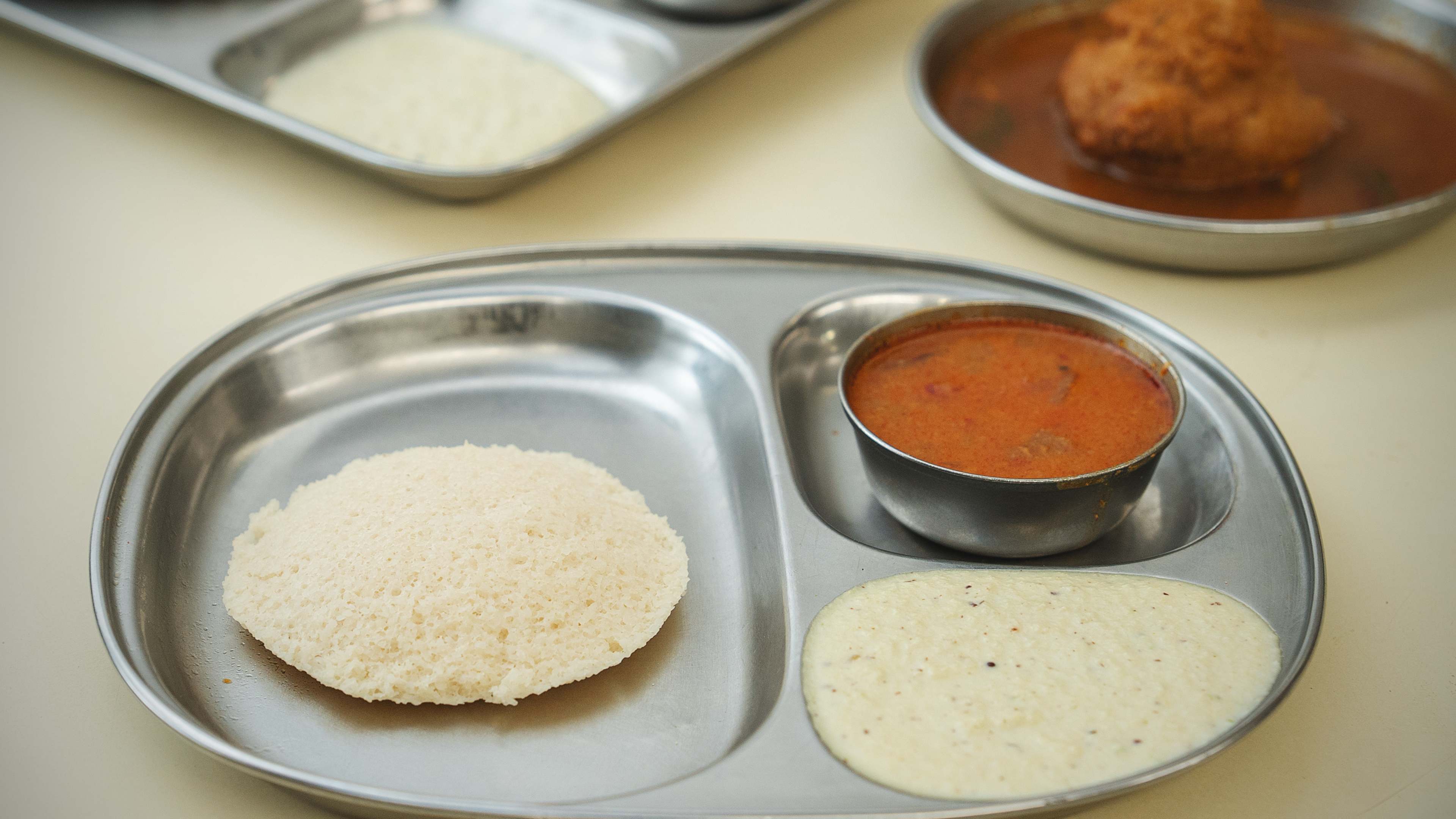 Steamed idli on tin platter at Cafe Madras