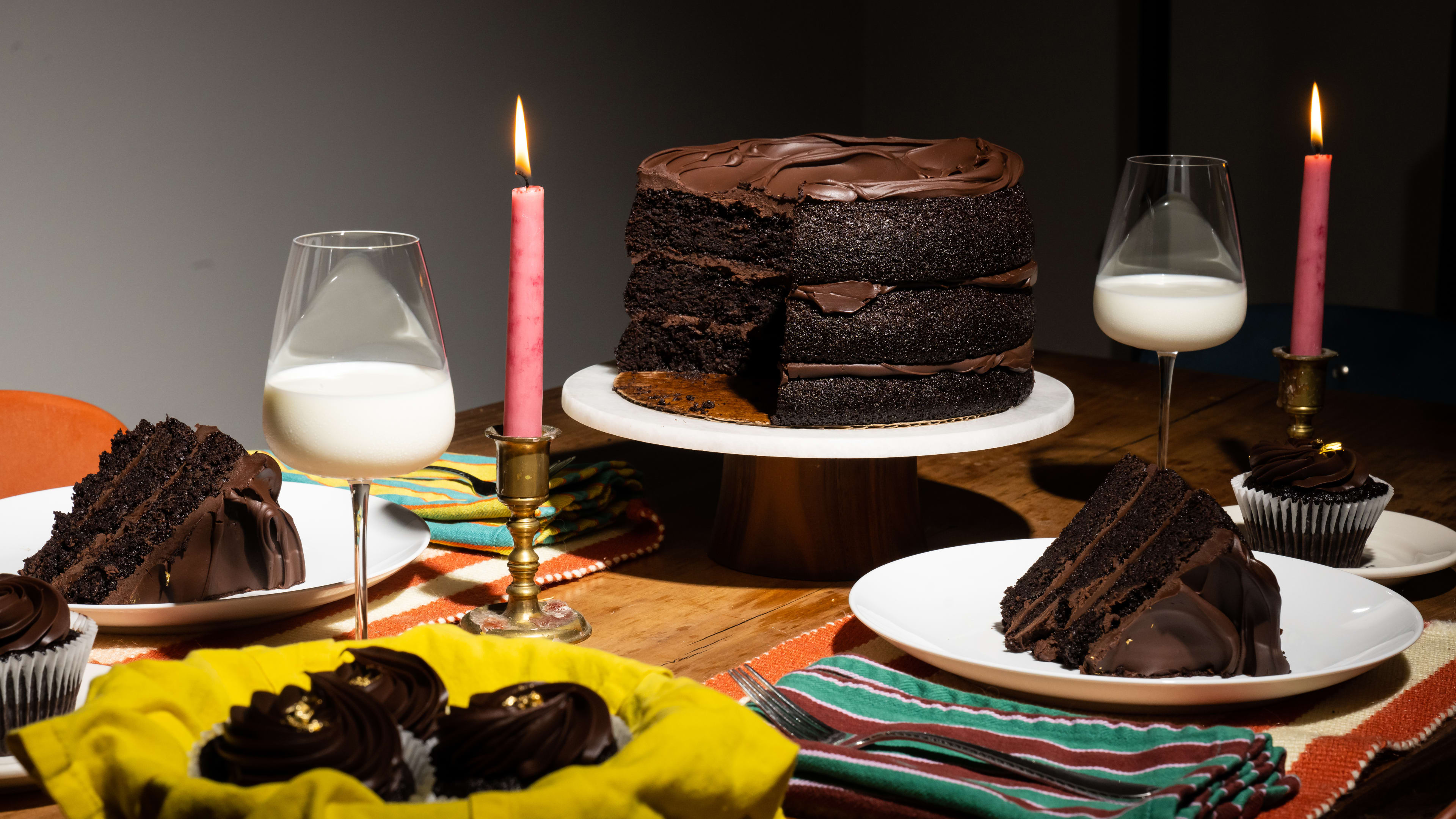 Dinner scene with chocolate cake and wine glasses of milk