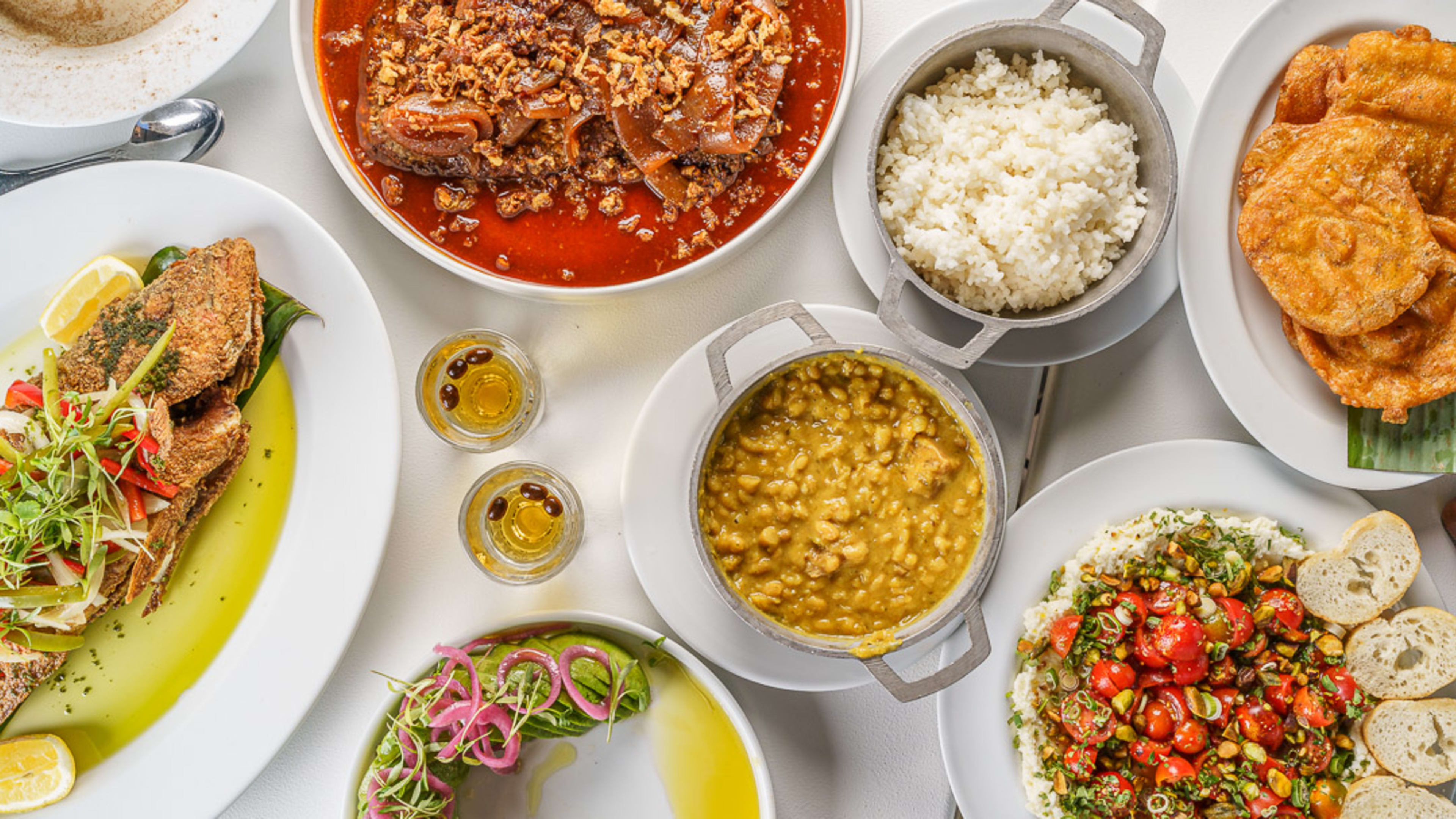 Mixed dishes on a table shot from above at Casita Miramar, a restaurant in San Juan