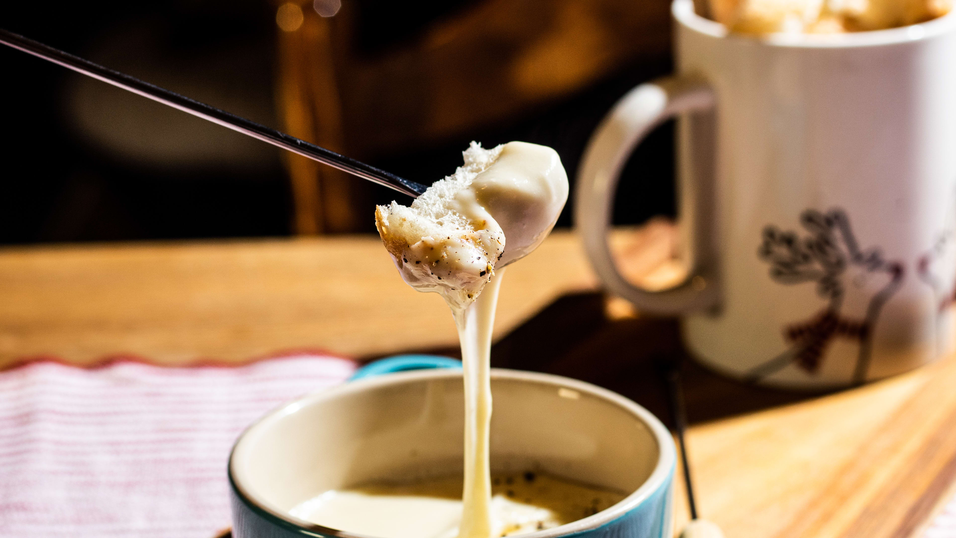 A piece of bread dipped into fondue.