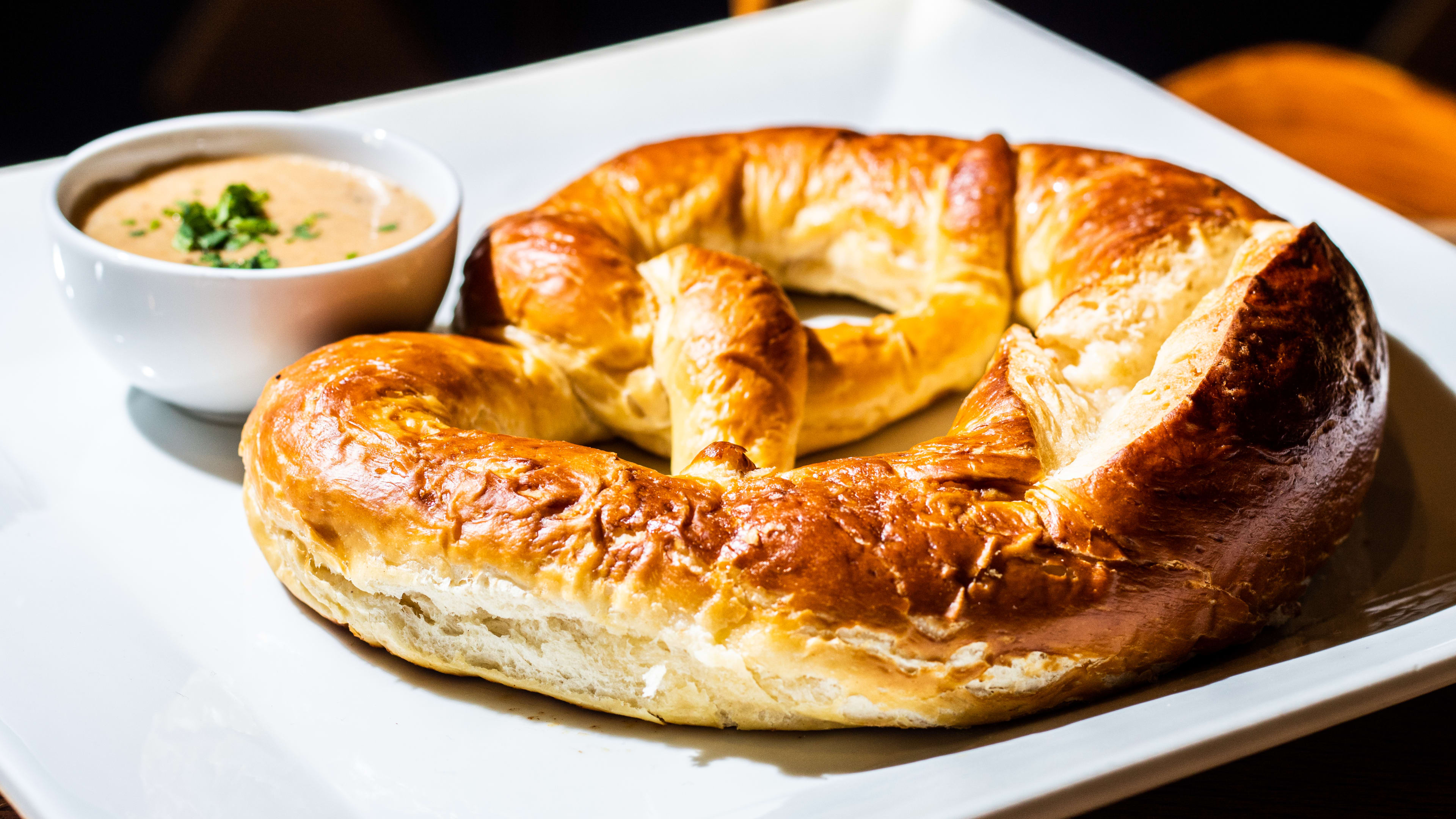 A big pretzel on a plate.