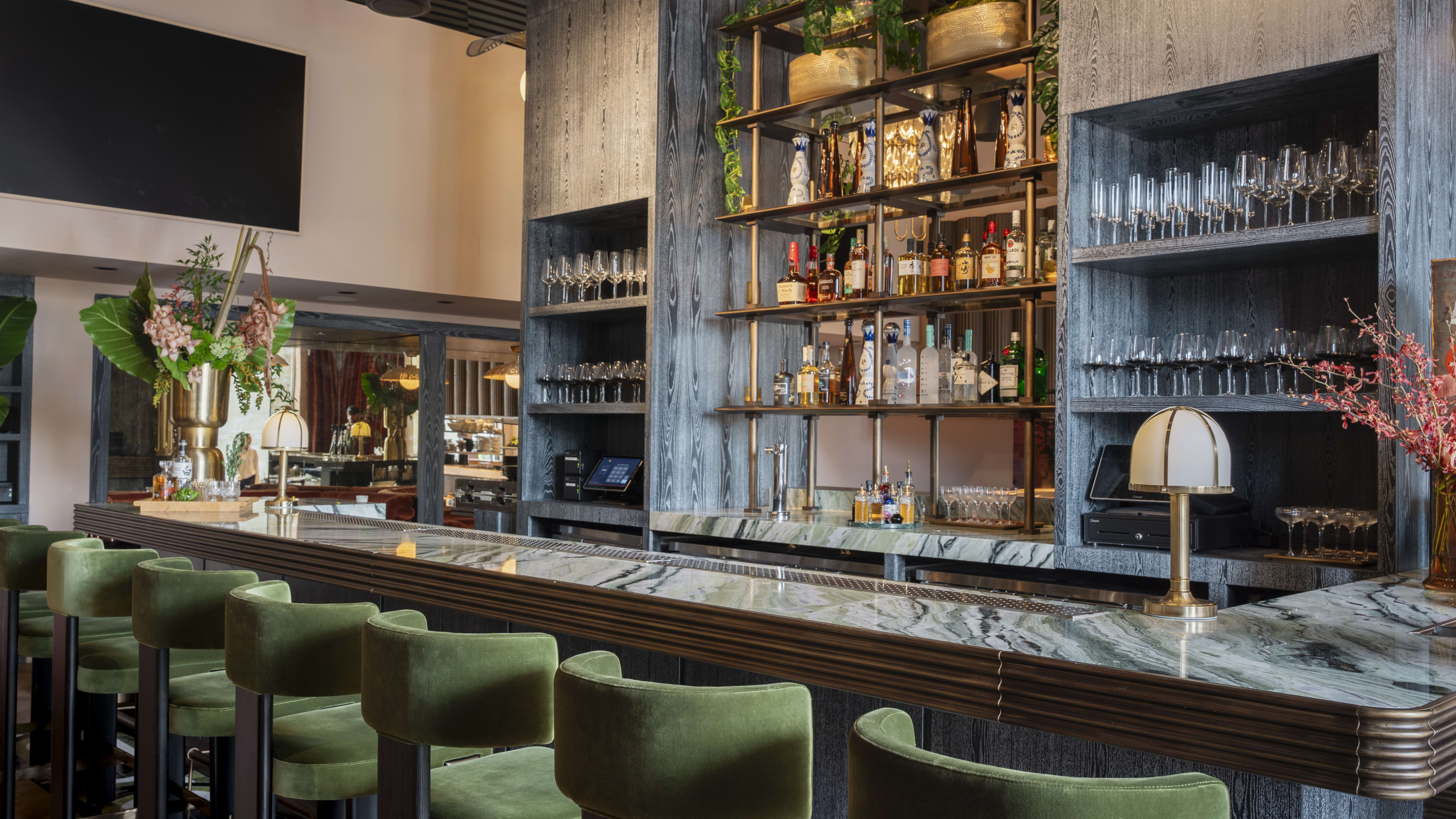 bar with velvet stools and marble counter