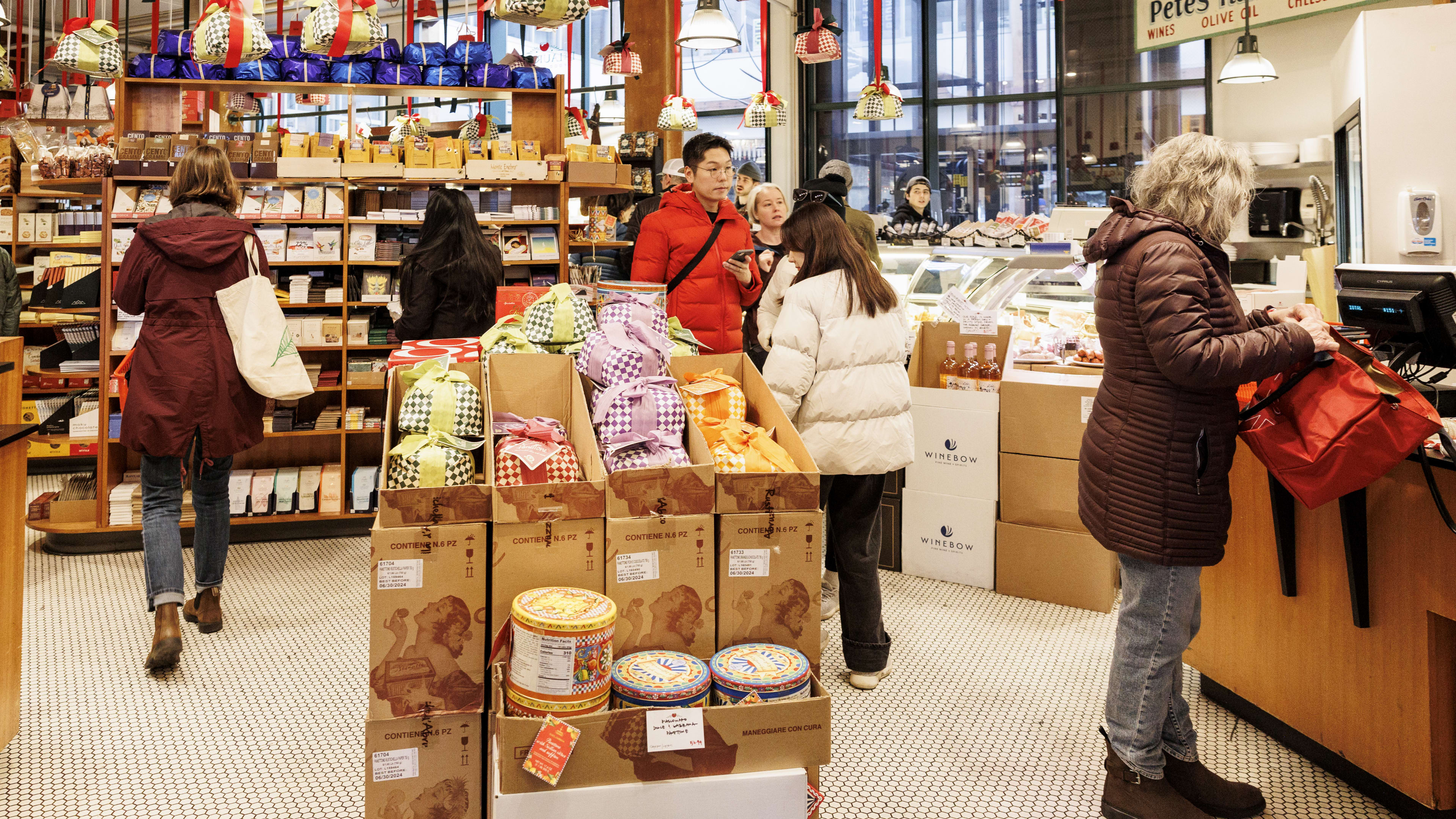 Grocery store interior with food displays and a butcher case.