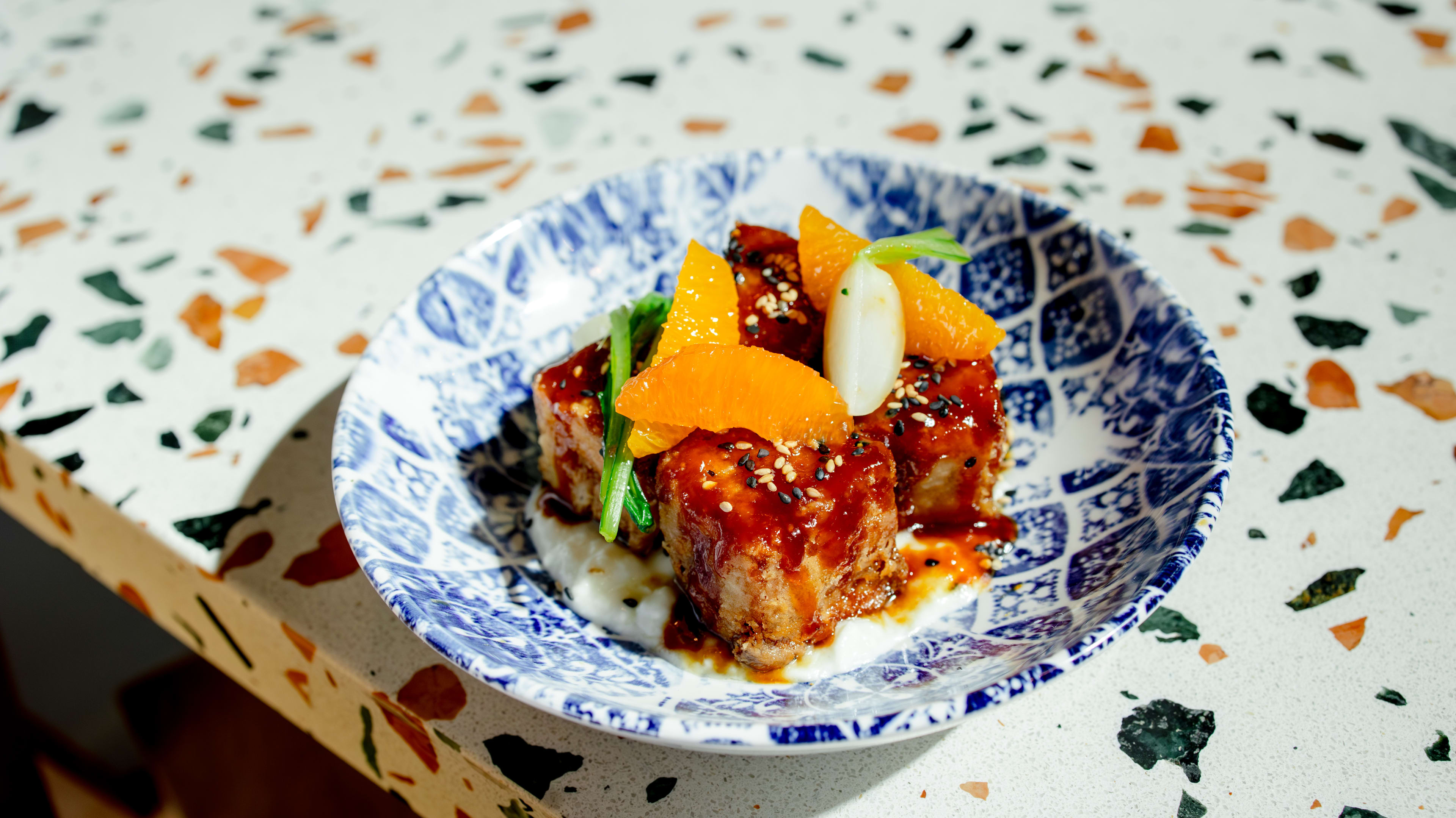 glazed pork belly on ceramic dish