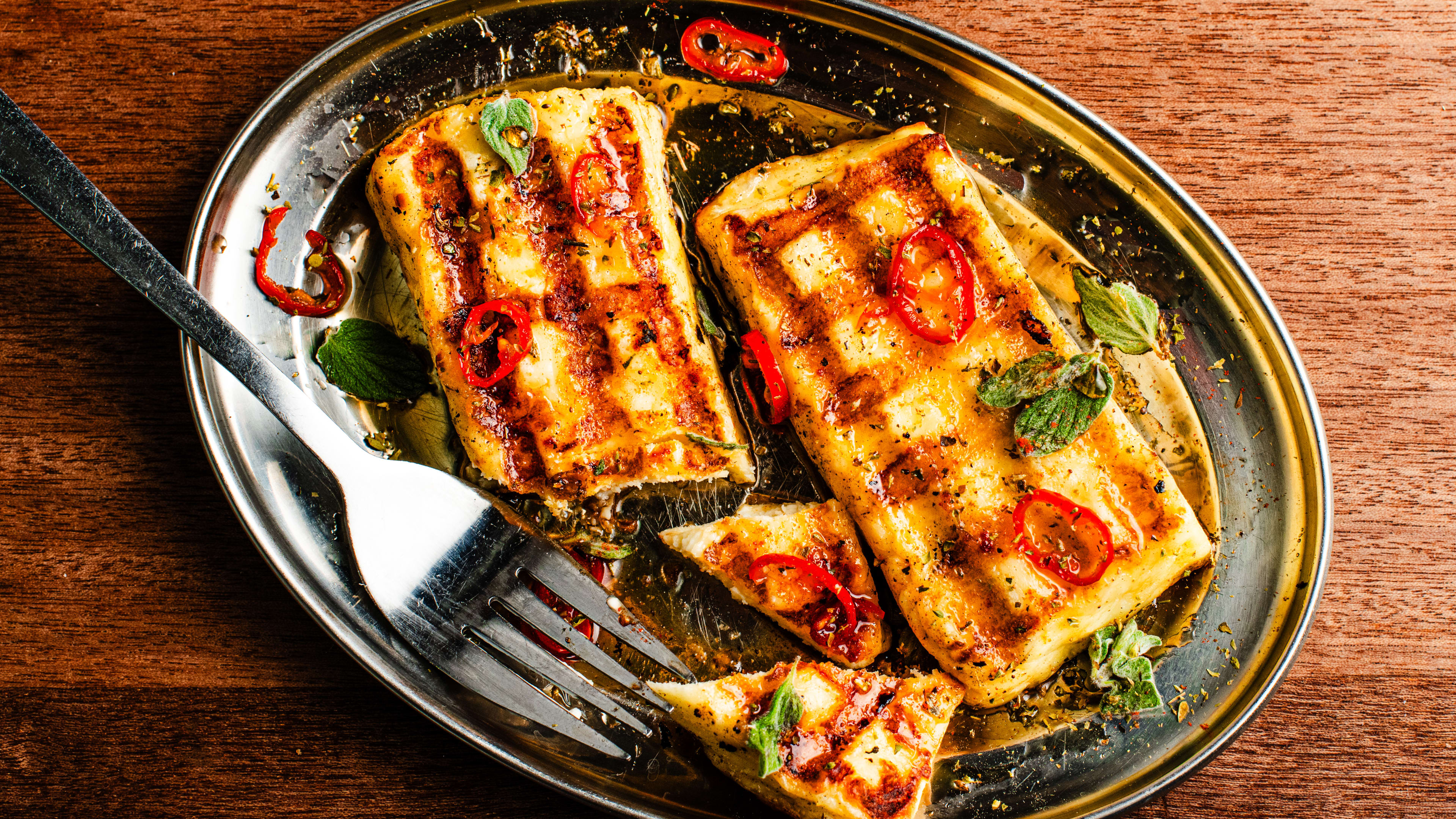 A fork cuts into the grilled halloumi from Evi's.