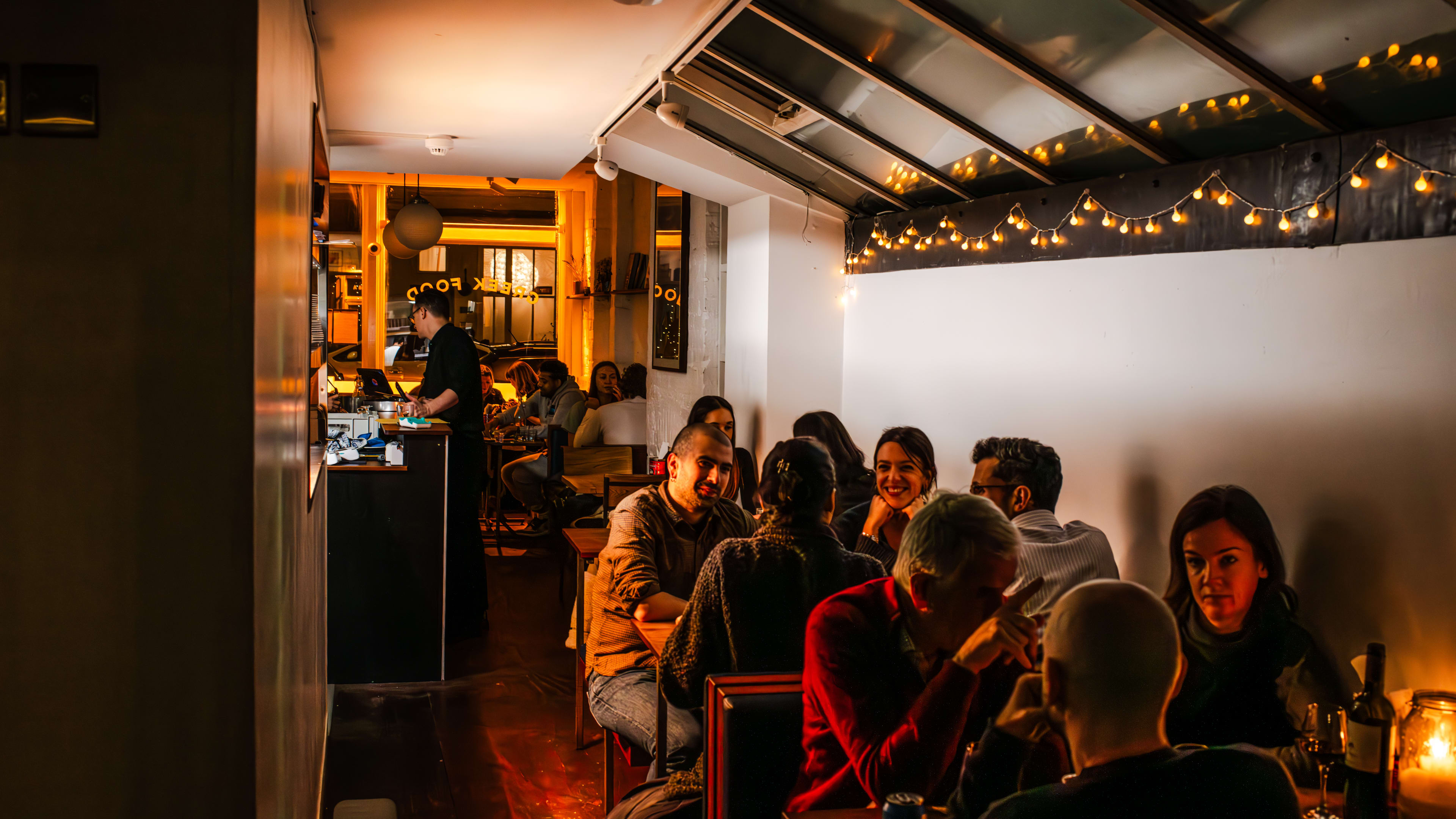 People sit at the booths tucked into the back dining area at Evi's.