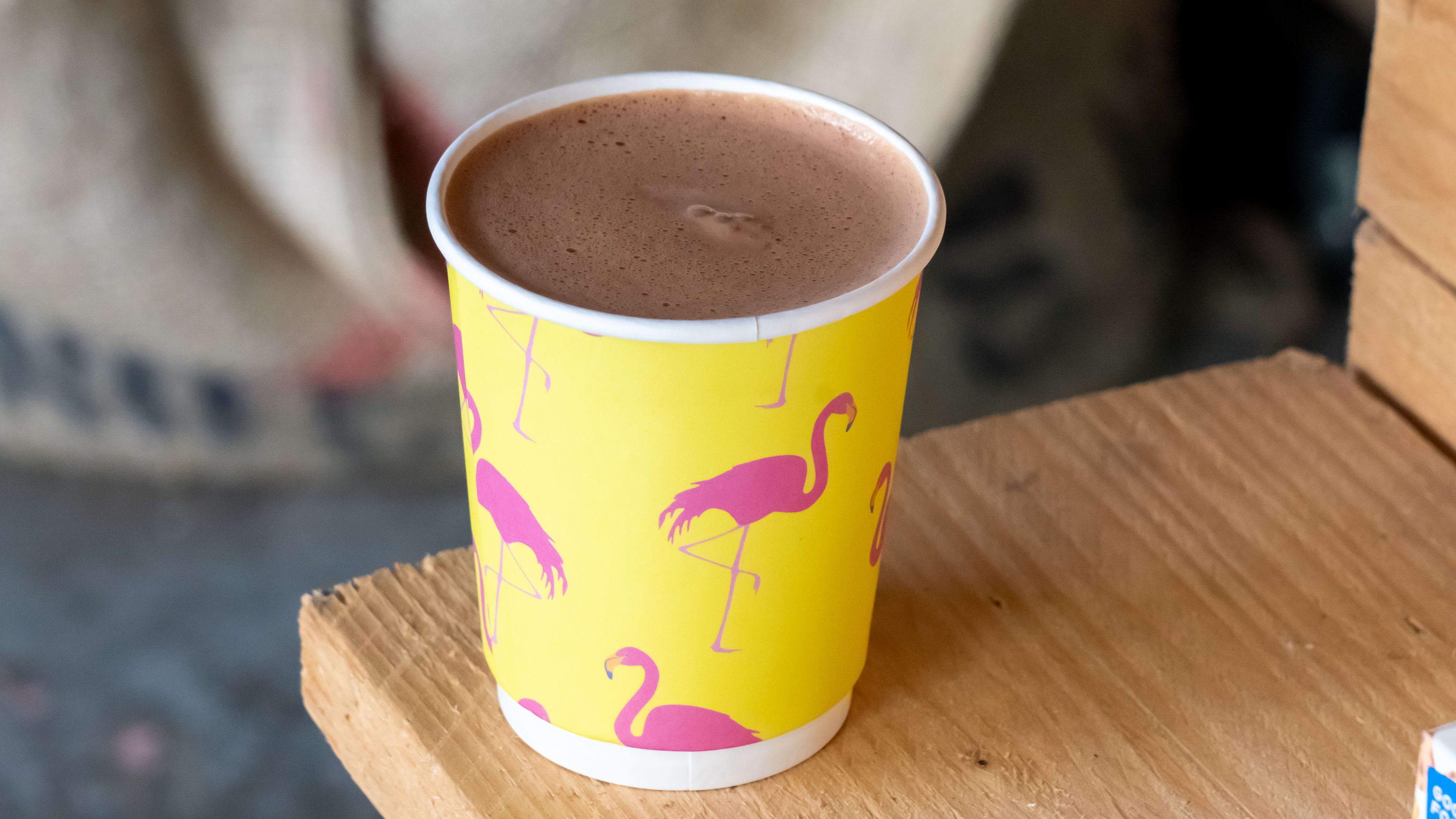 Paper flamingo-printed cup filled with thick hot chocolate