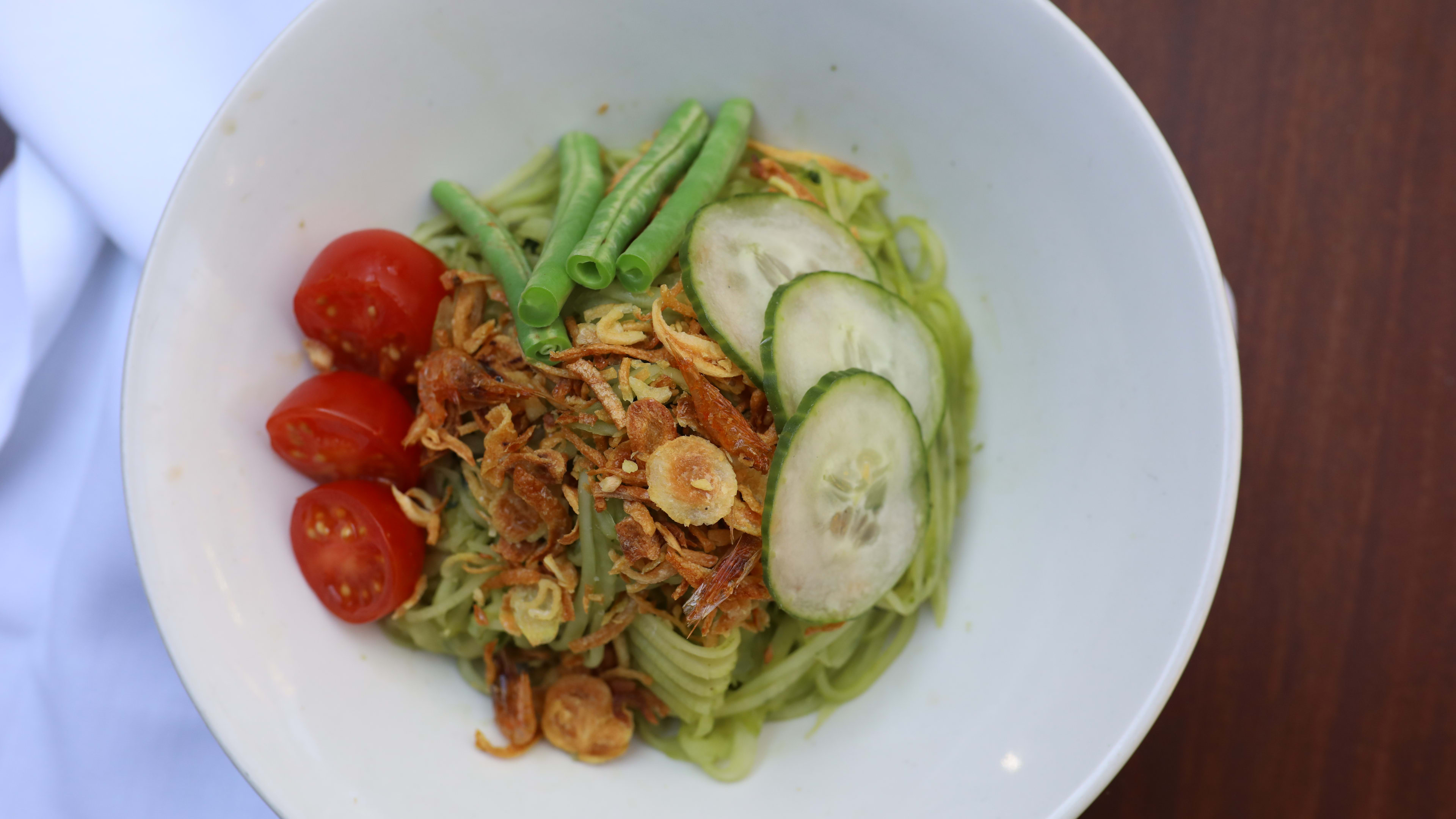 A dish with noodles, vegetables and nuts from Sway.