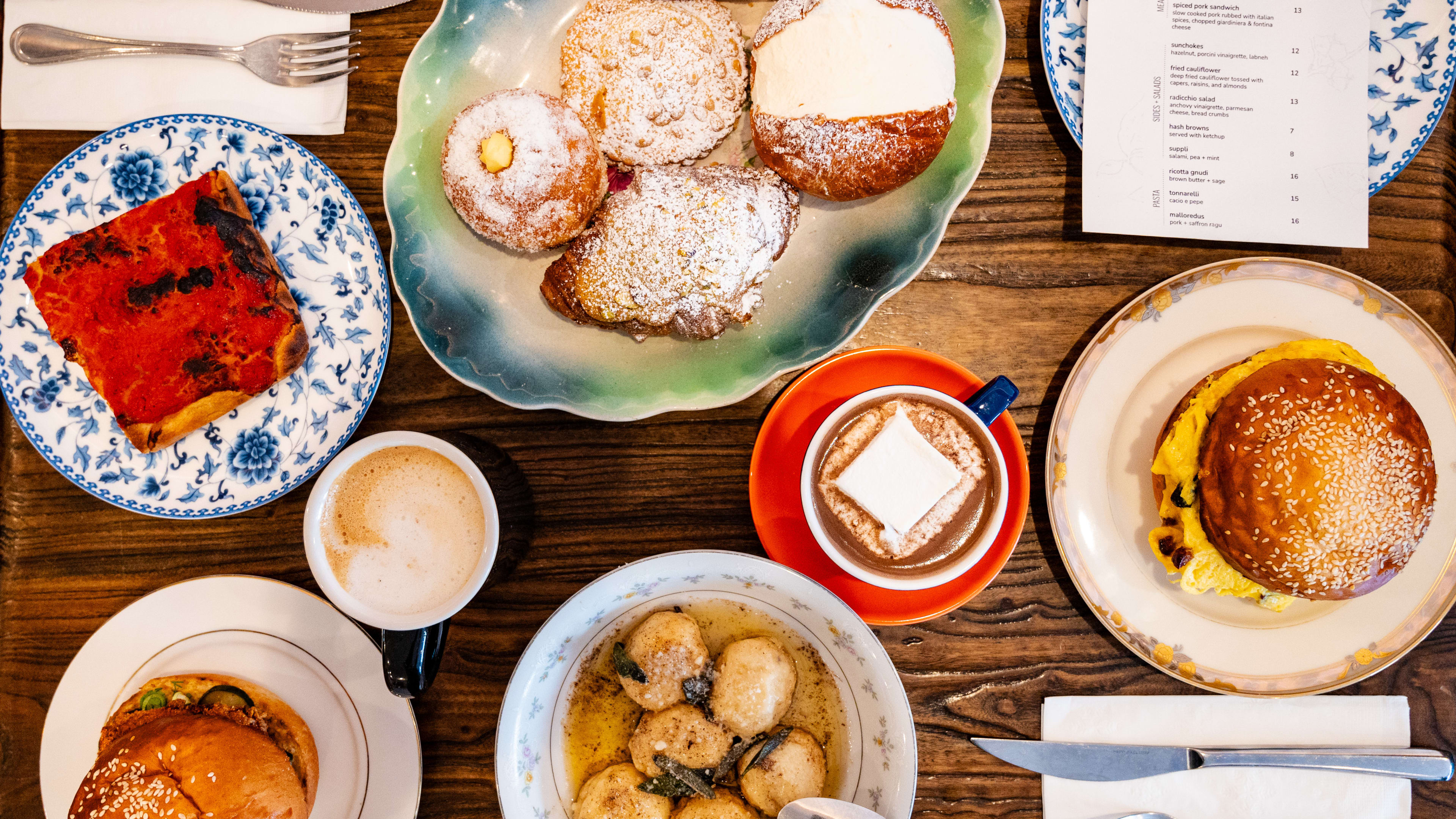 This is a spread of pastries, hot chocolate, tomato pie, and sandwiches from Fiore.