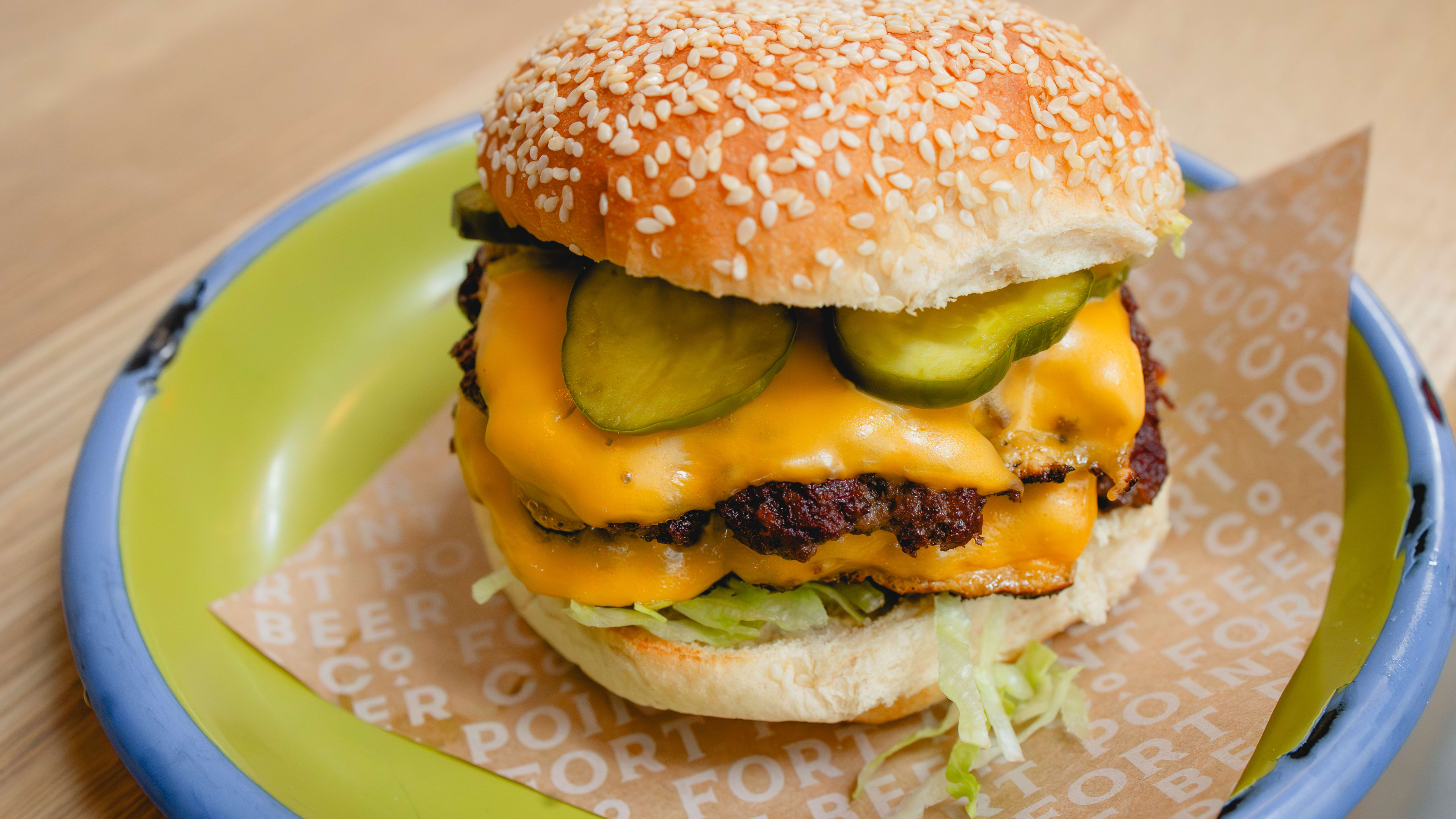 double patty smashburger with pickles and sesame seed bun