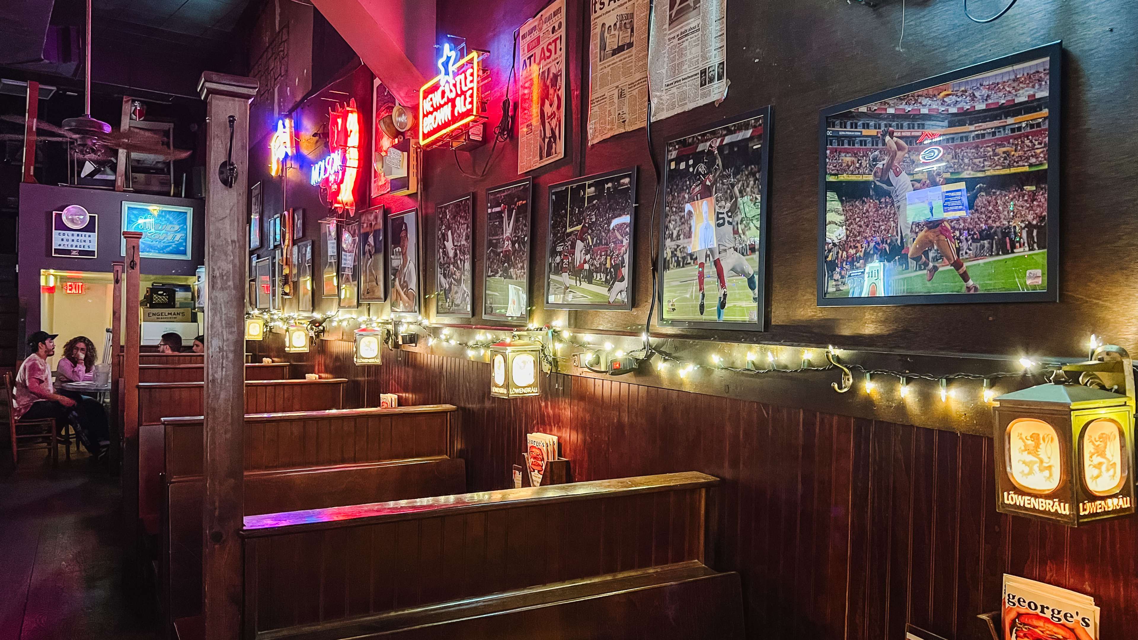 Wooden booths and neon signs in the interior of George's.