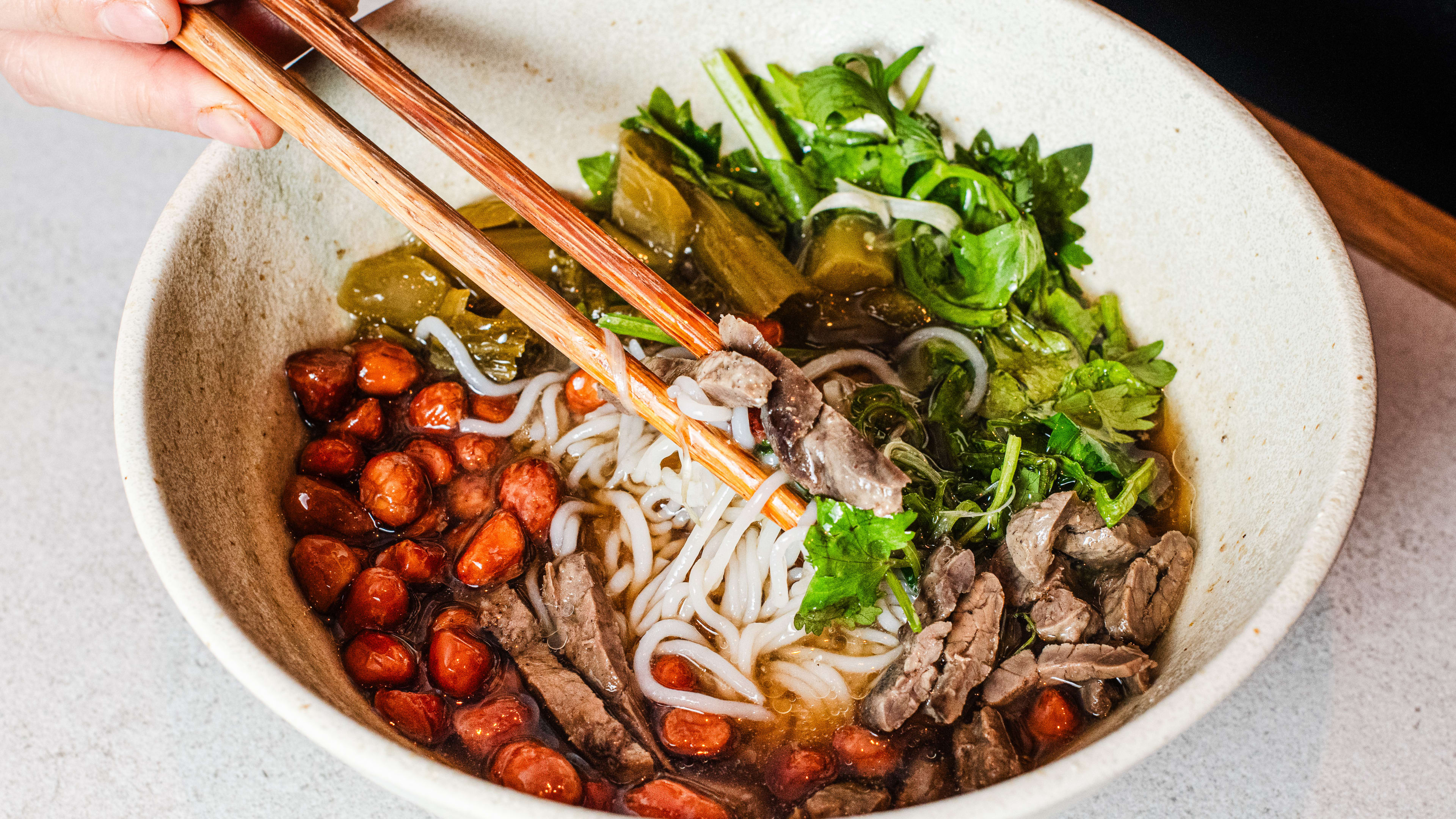 A rice noodle bowl with beef jerky.