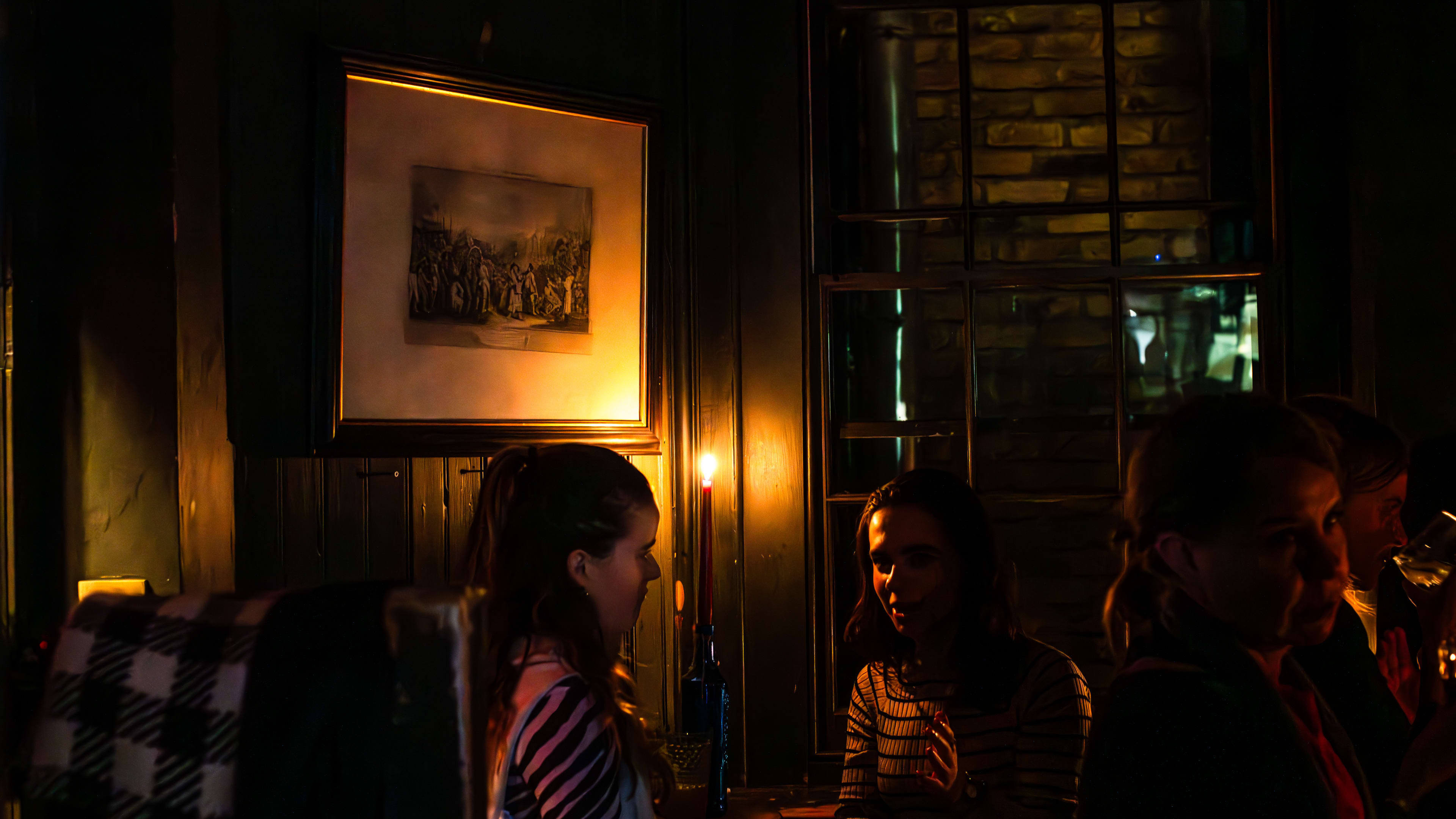 Two friends having a drink inside of The Holy Tavern.