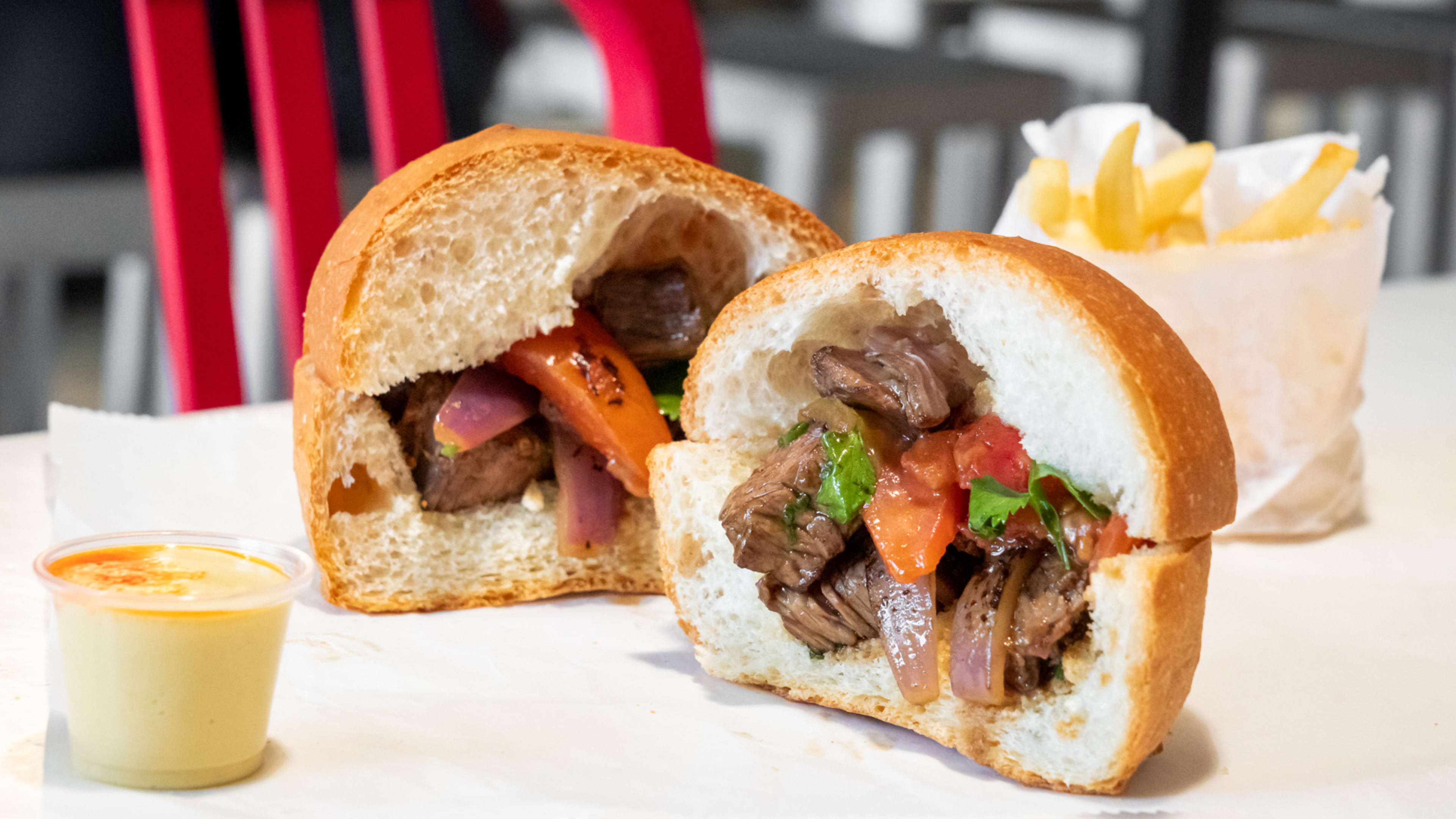 A cross section of the lomo saltado sandwich.