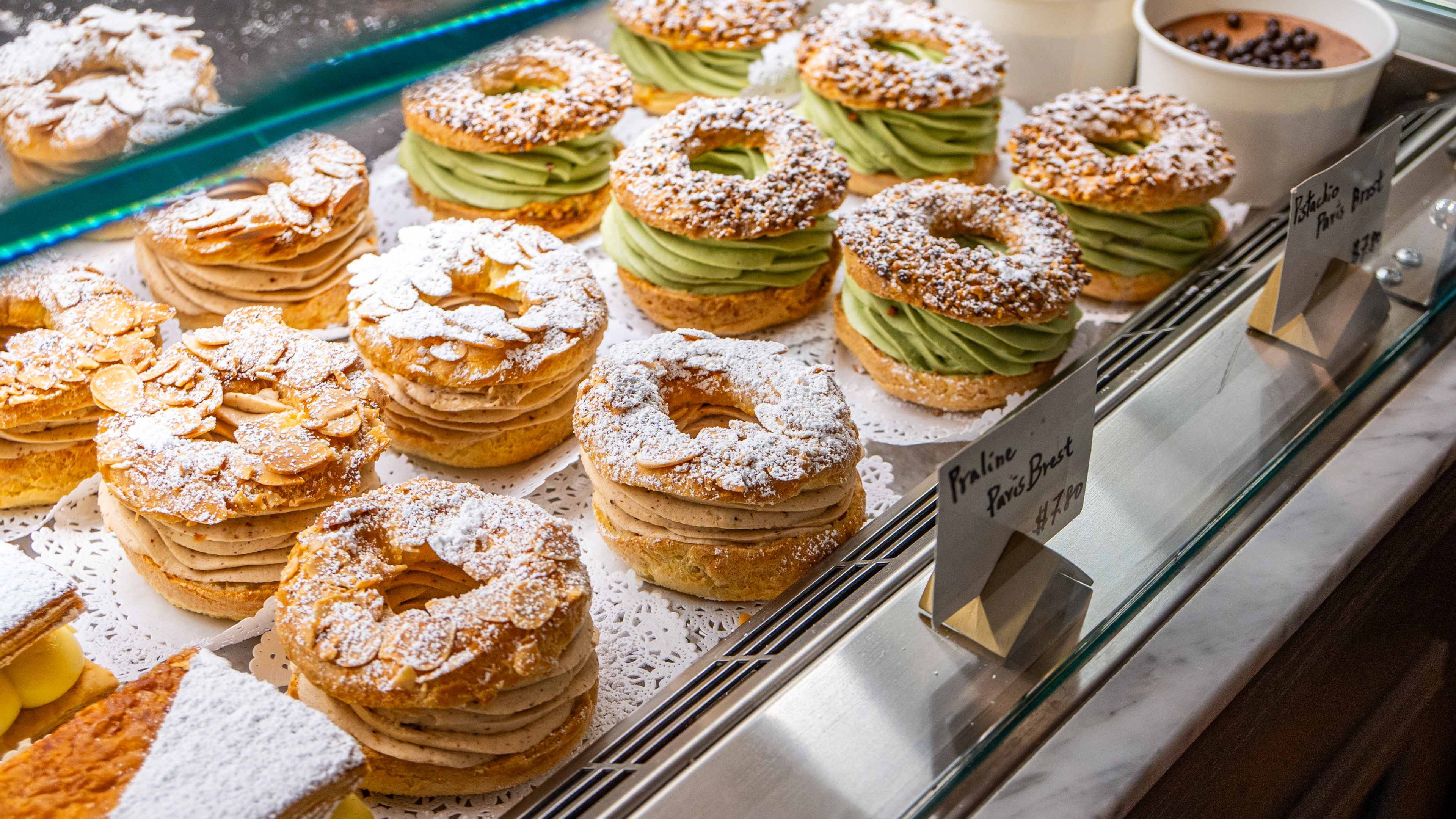 close up shot of cream-filled pastries in display case