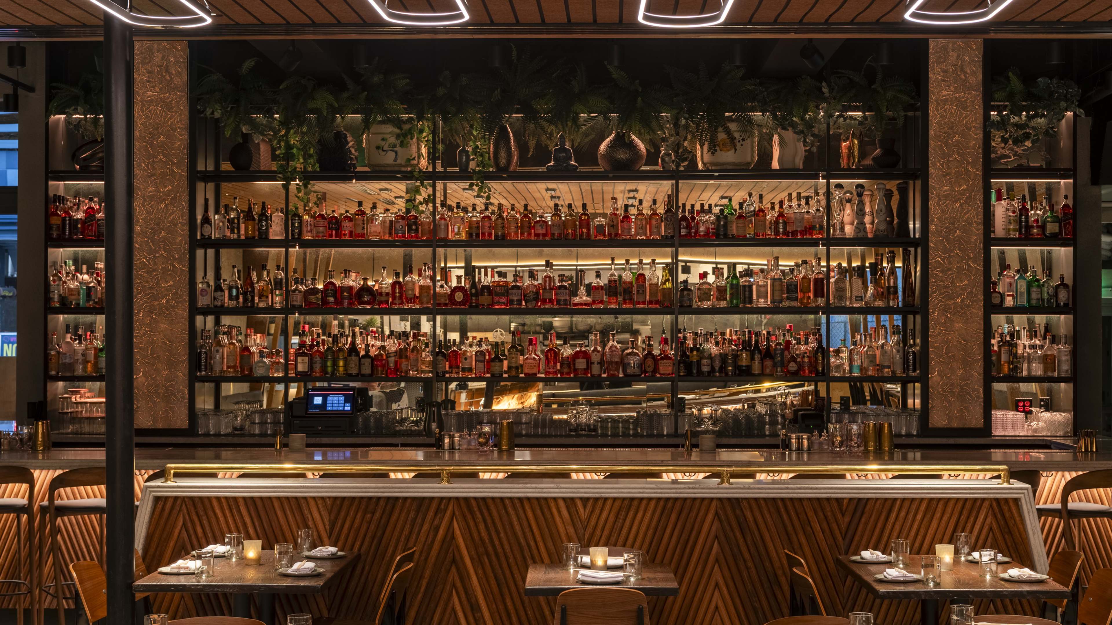 Restaurant interior with bar seating and alcohol shelves