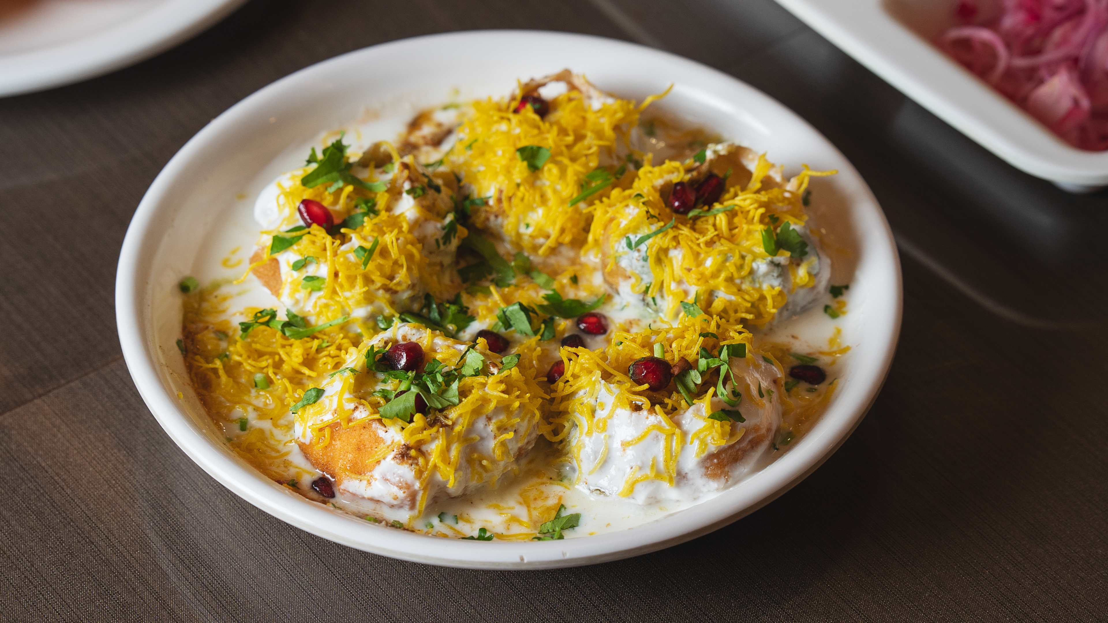 Dahi Puri topped with coconut shavings and pomegranate seeds at Kailash Parbat