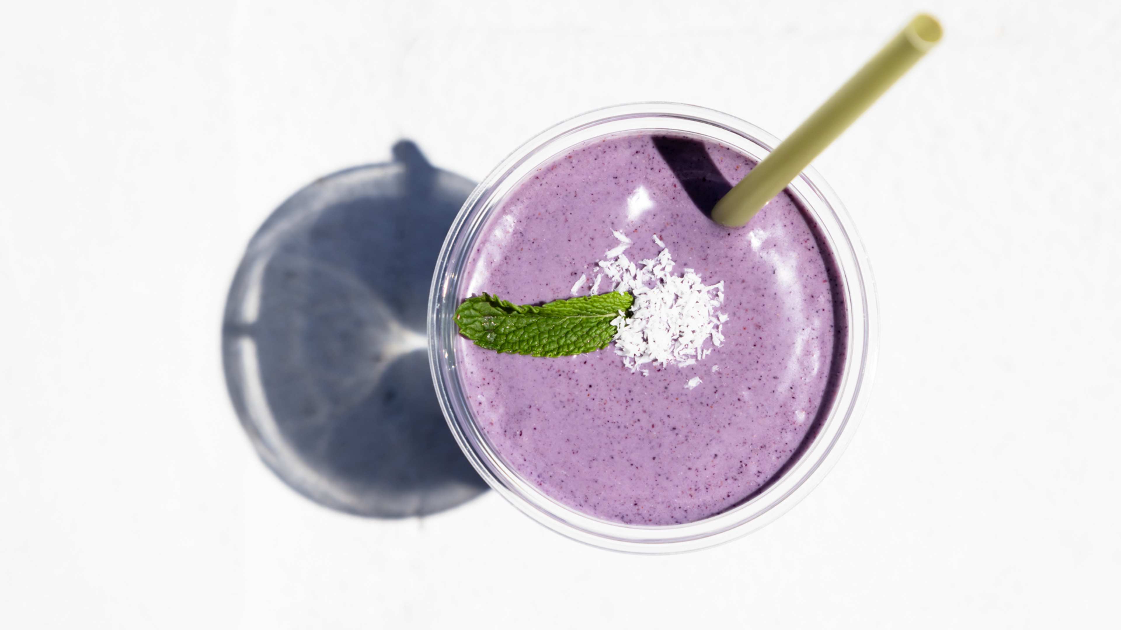 purple smoothie with mint and coconut flakes