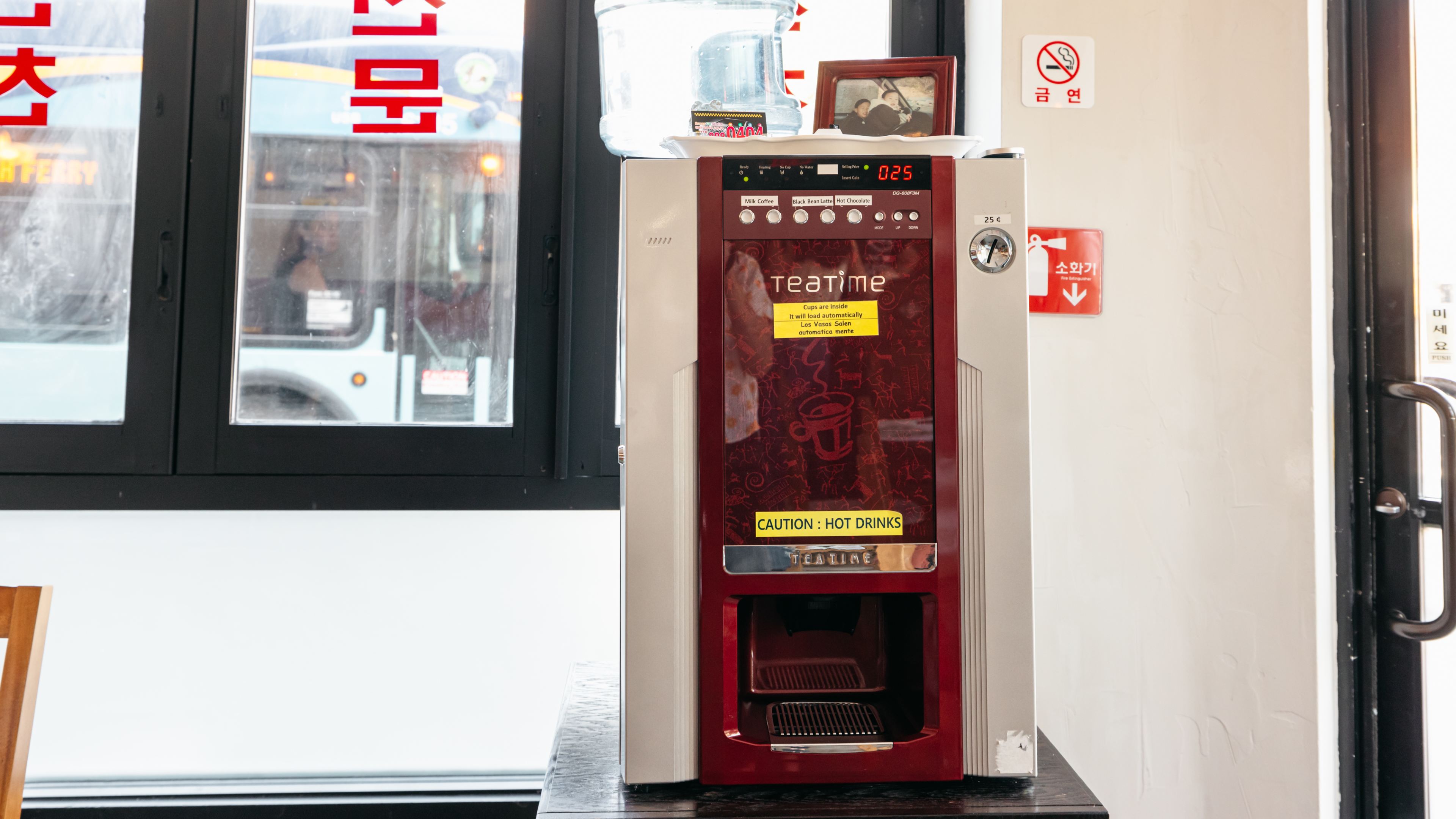 A coffee machine in the corner of a restaurant.