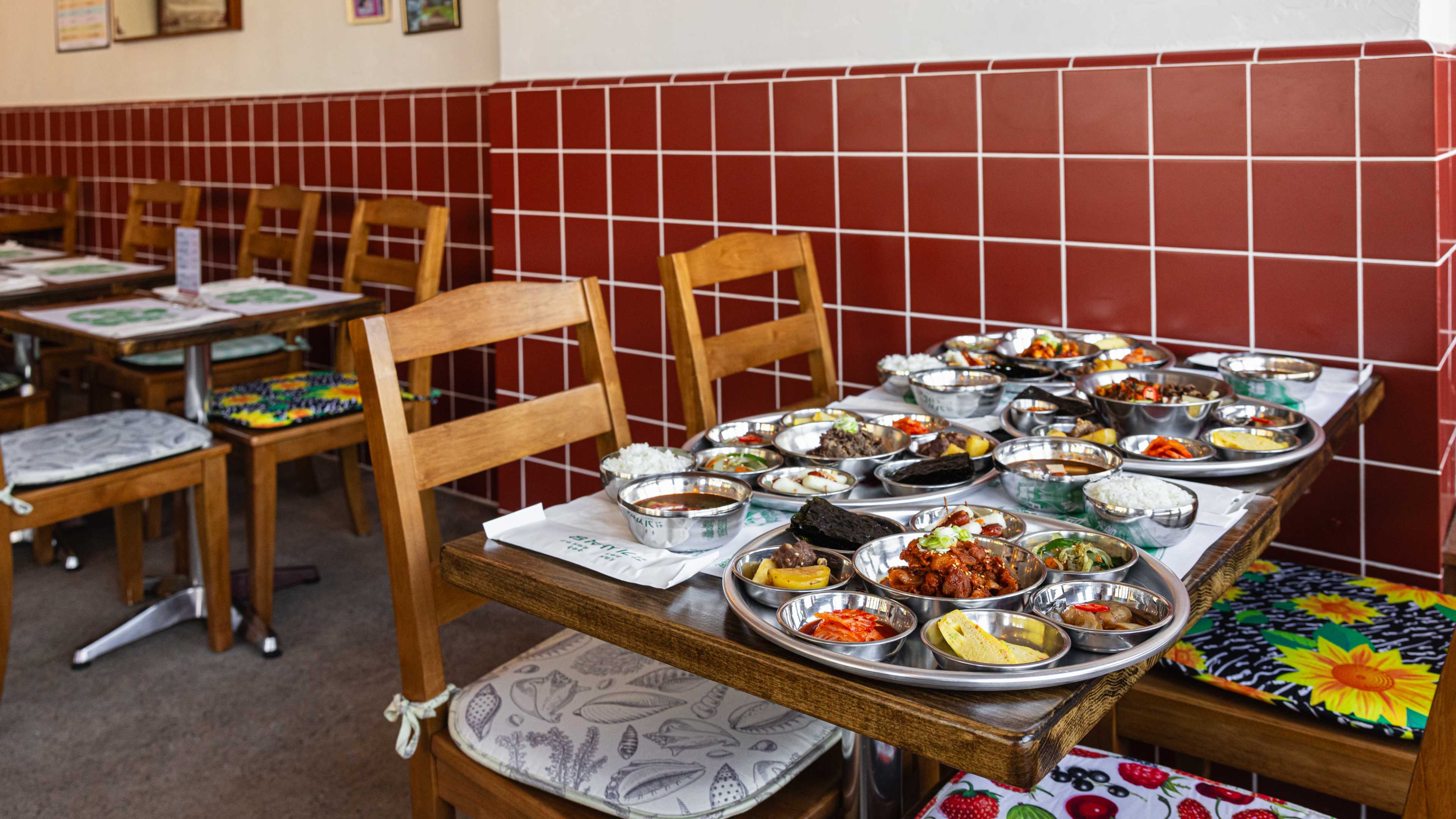 A table covered in trays of Korean food.