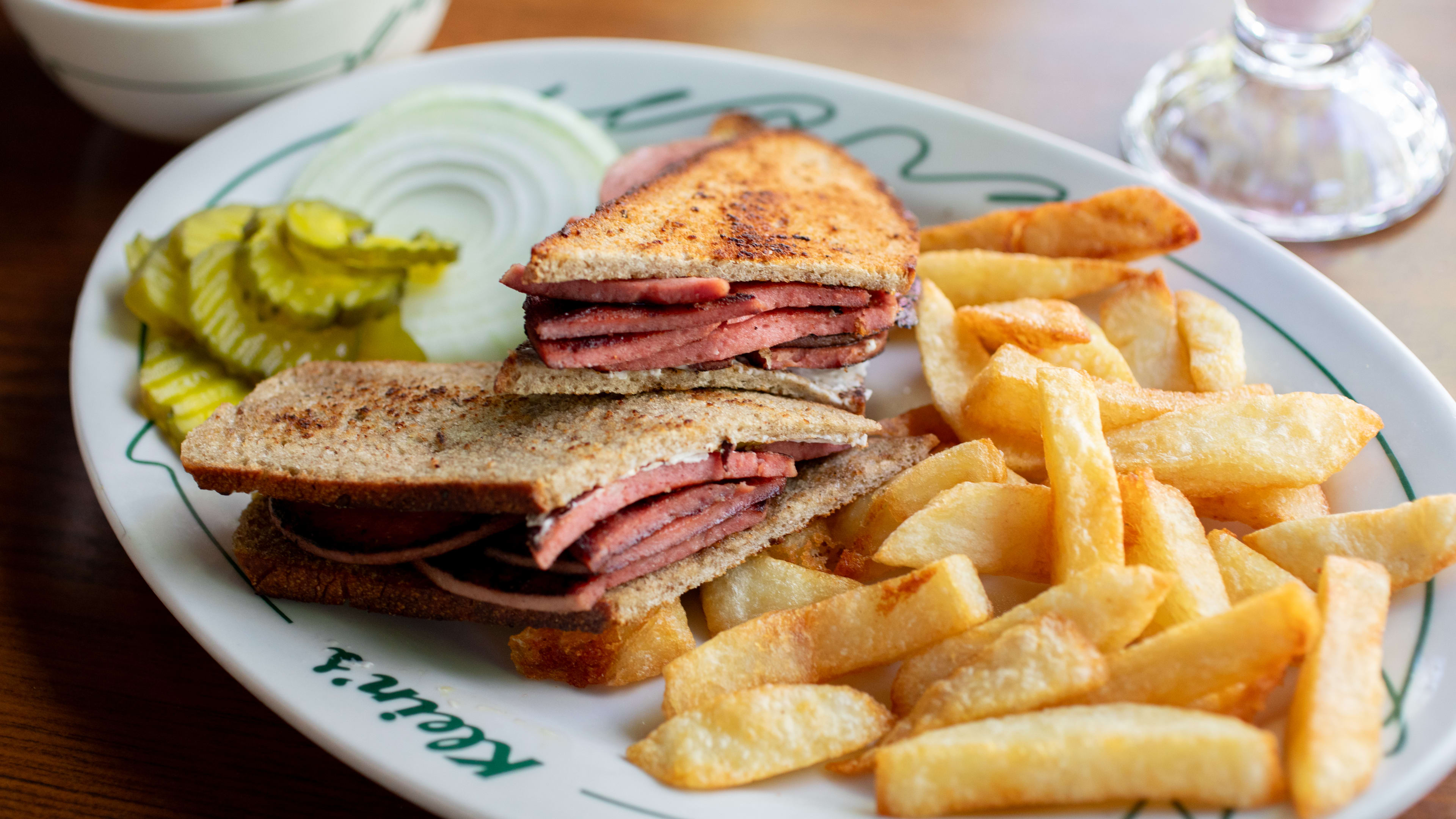 A sandwich and fries on a plate at Klein's, a restaurant in Mexico City