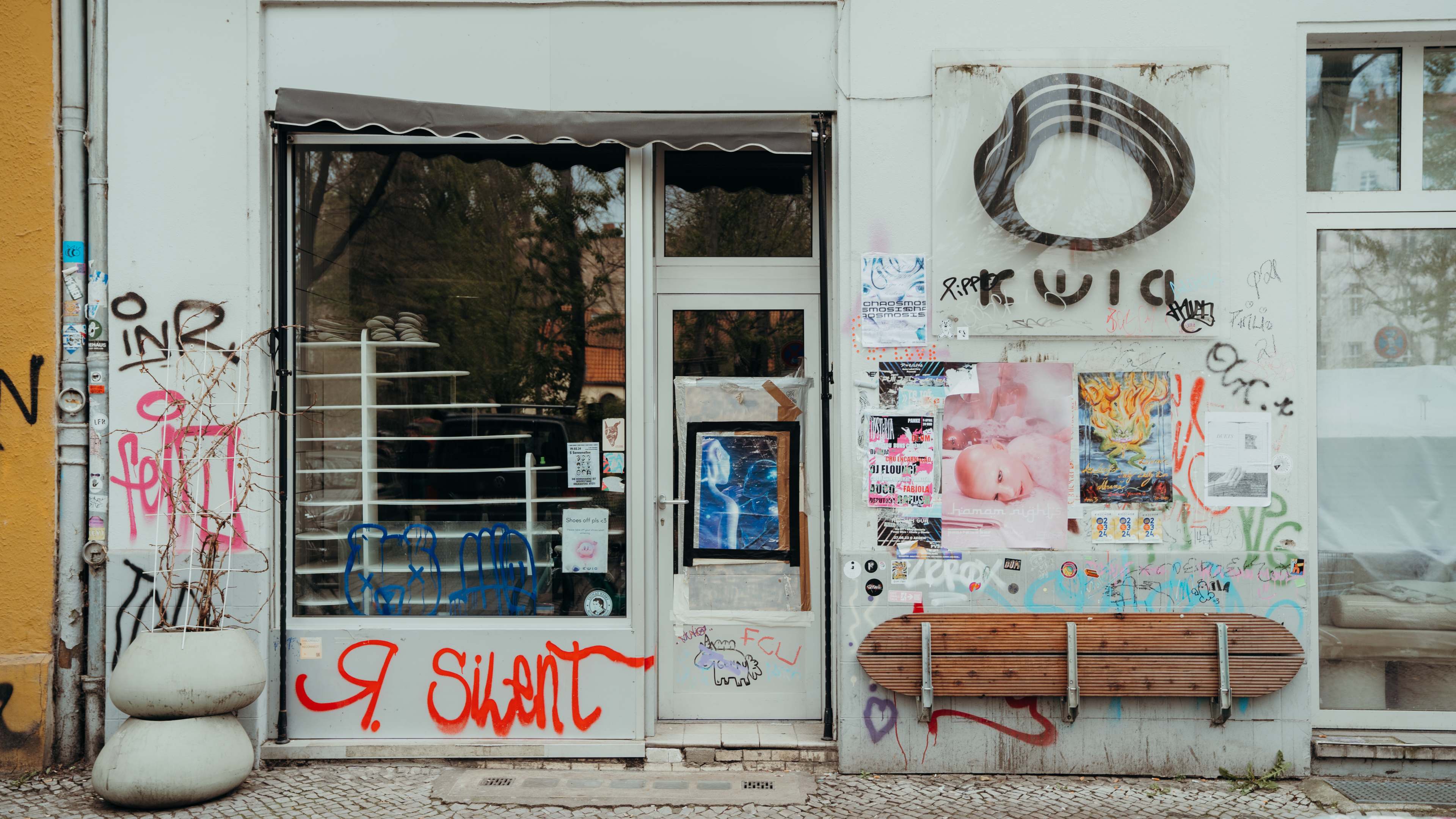 White painted exterior of Kwia covered with graffiti