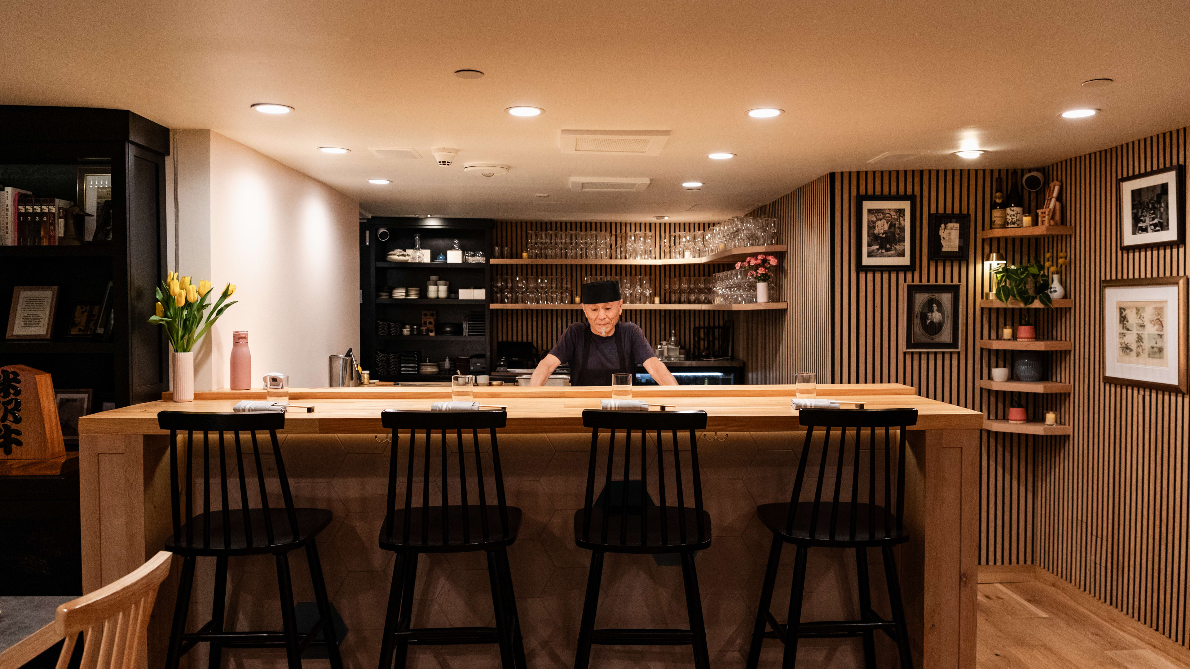 The four-seat sushi bar at Sushi Note Omakase. The sushi chef stands behind the bar.