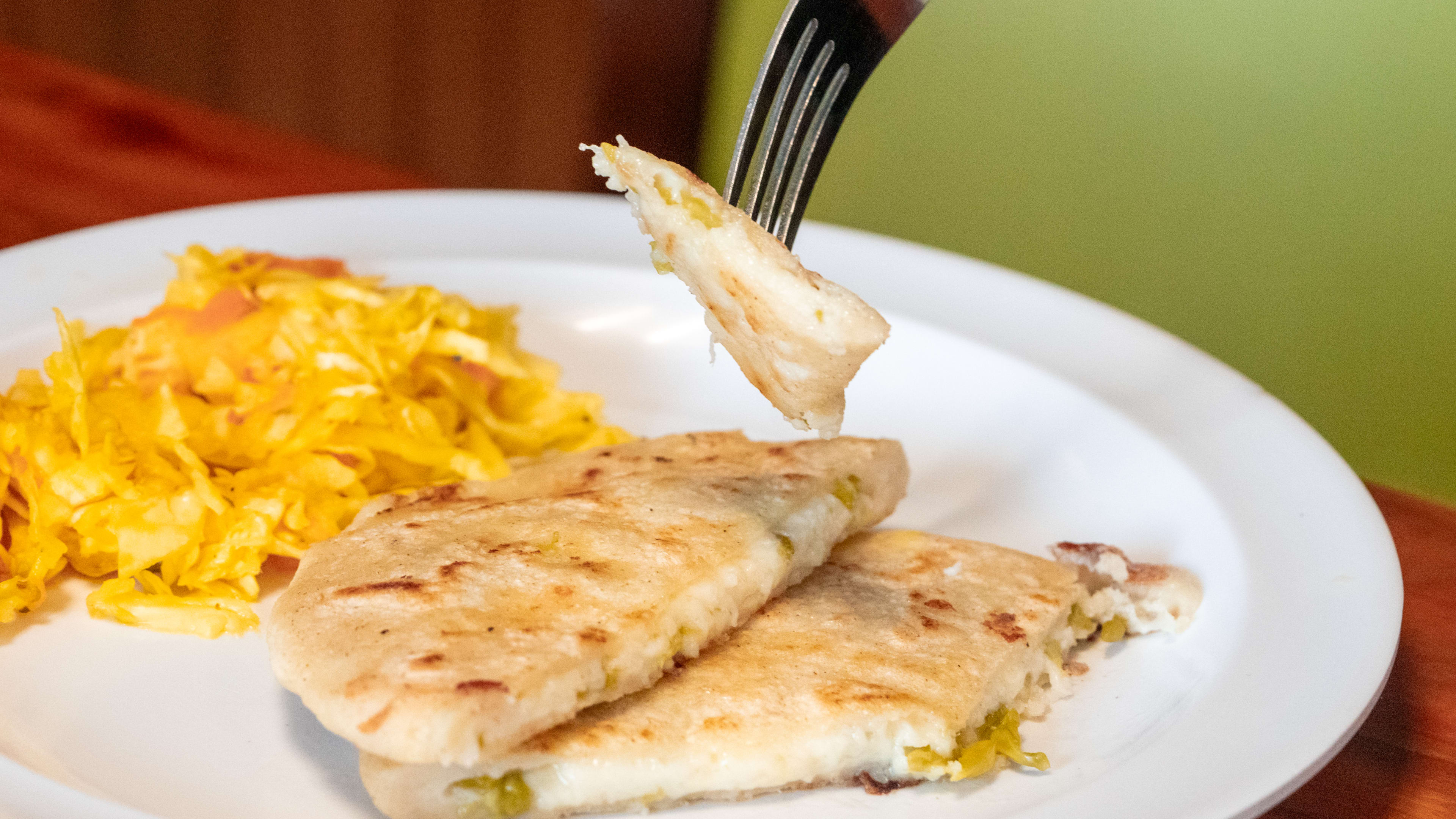 Pupusa with loroco and cheese and a side of yellow cabbage