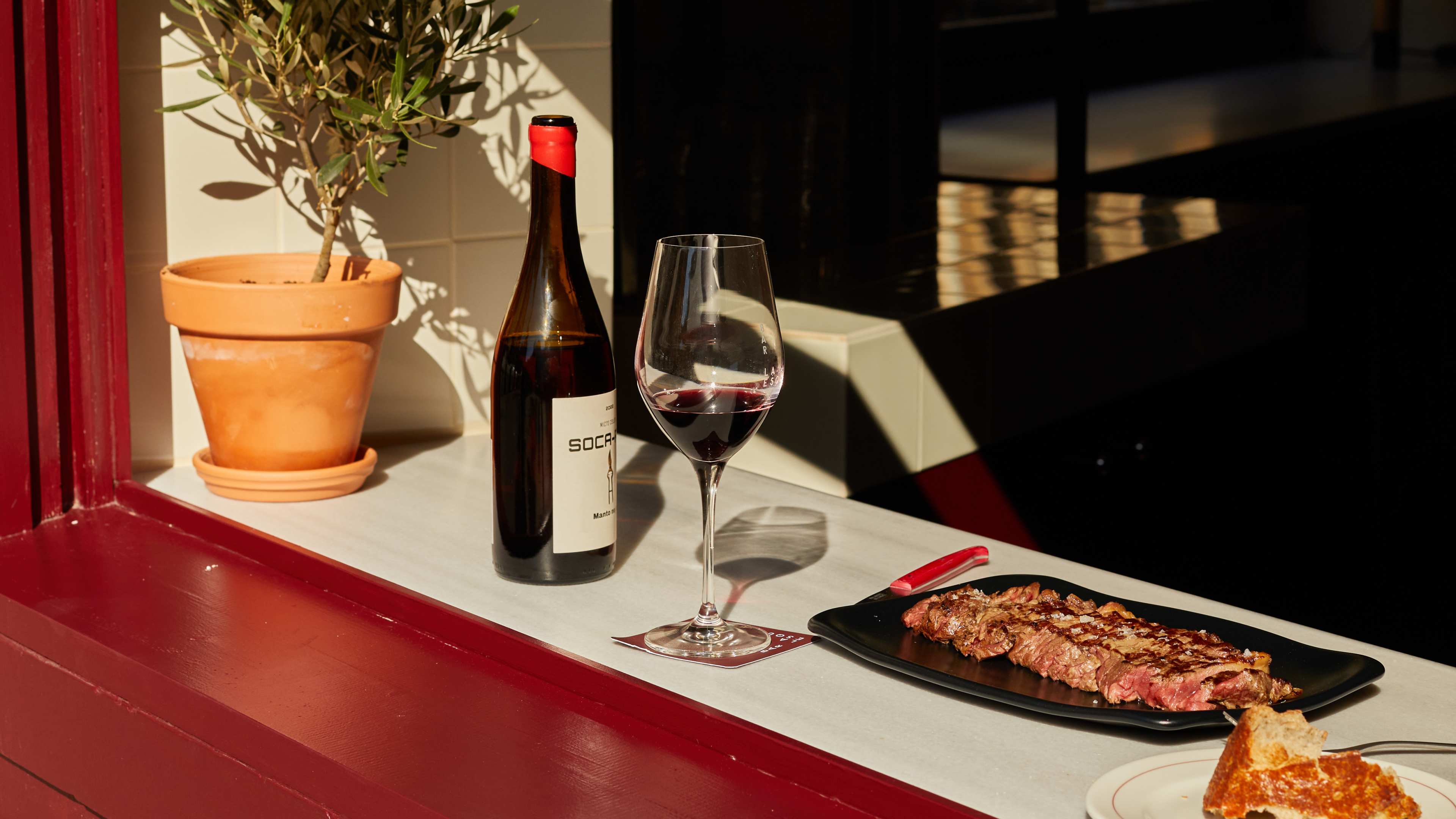 Spread of tapas dishes on red windowsill at La Esquina