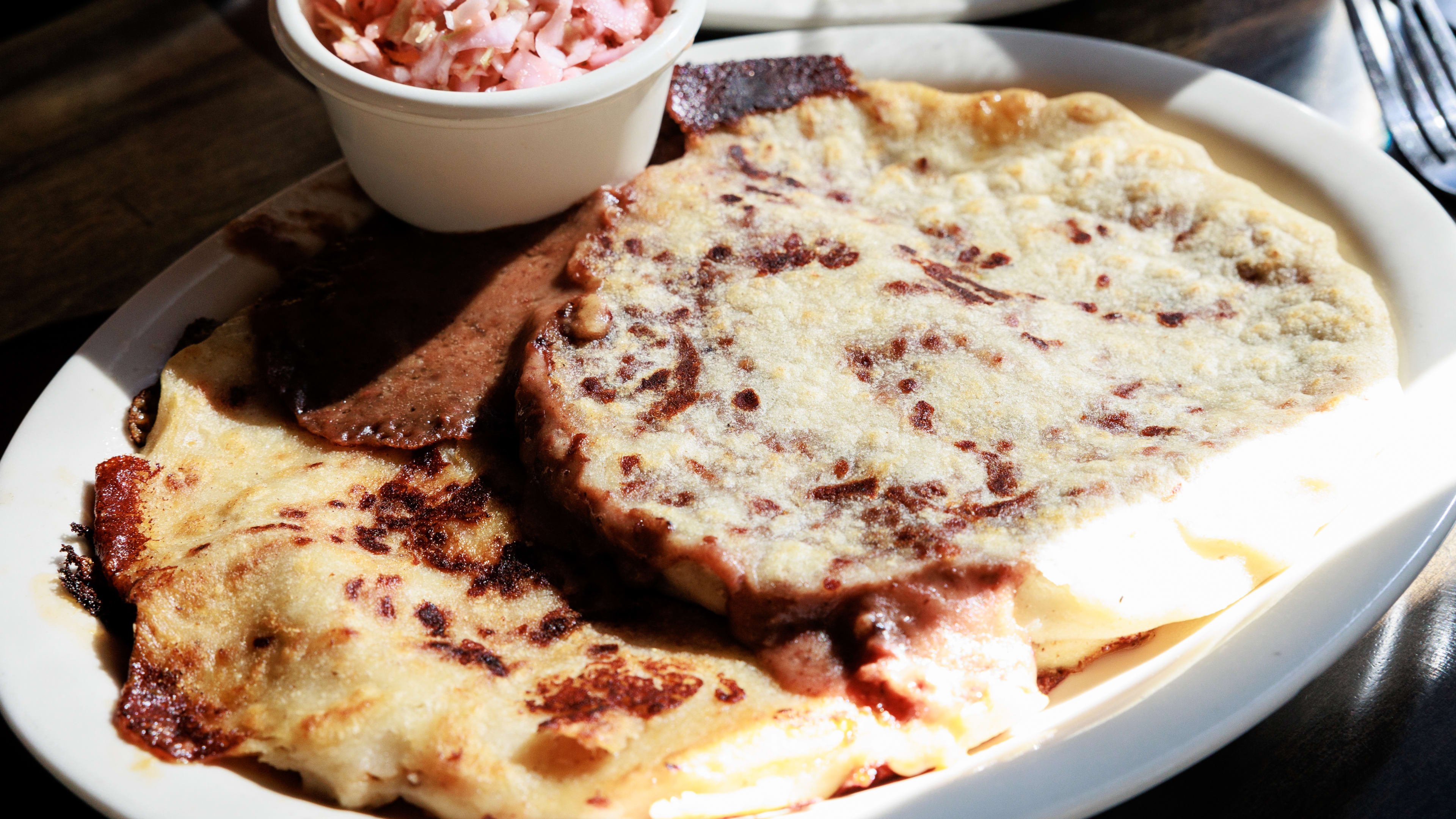 a plate of cheese-filled pupusas.