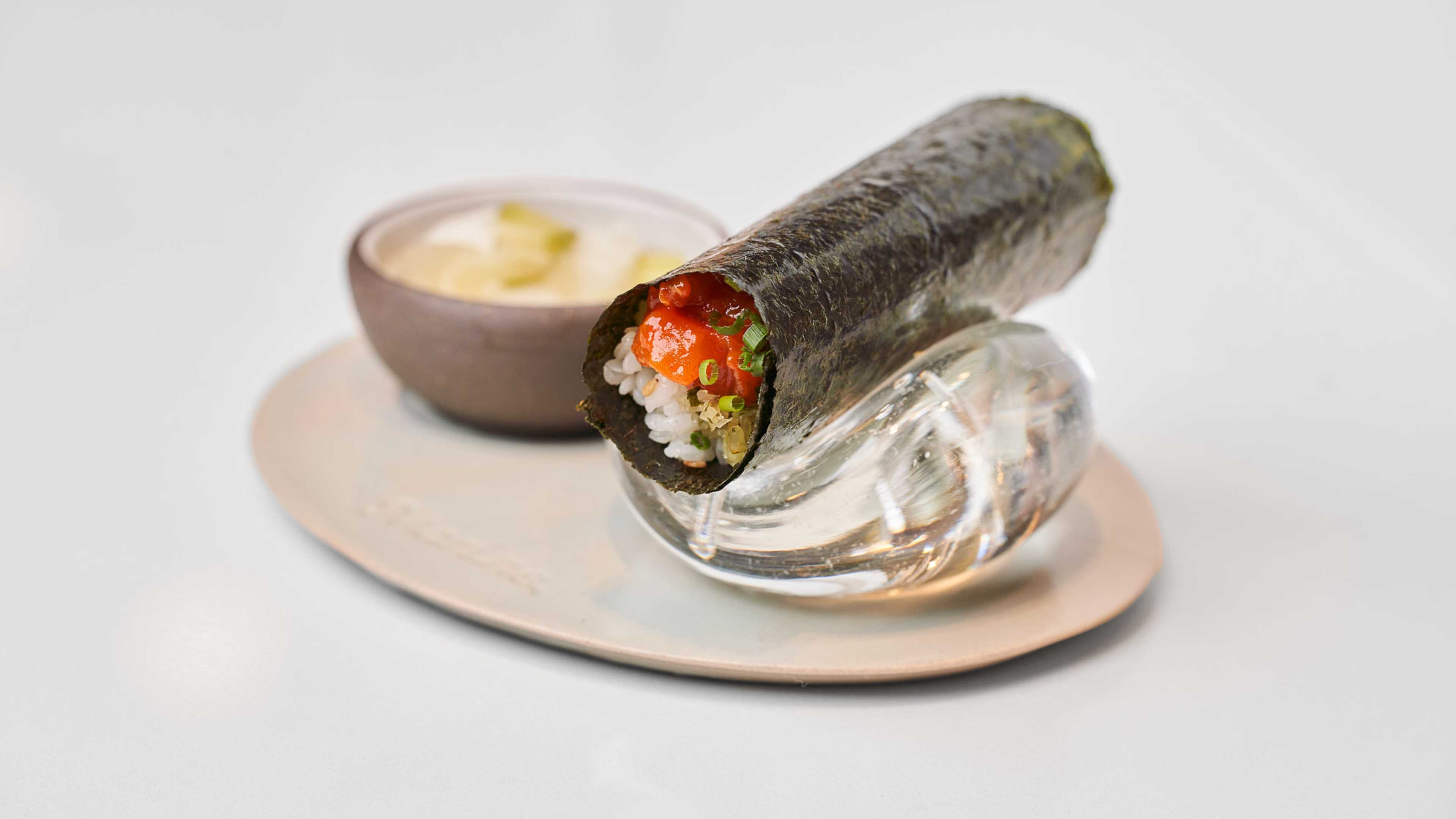 A handroll with rice and fish inside.