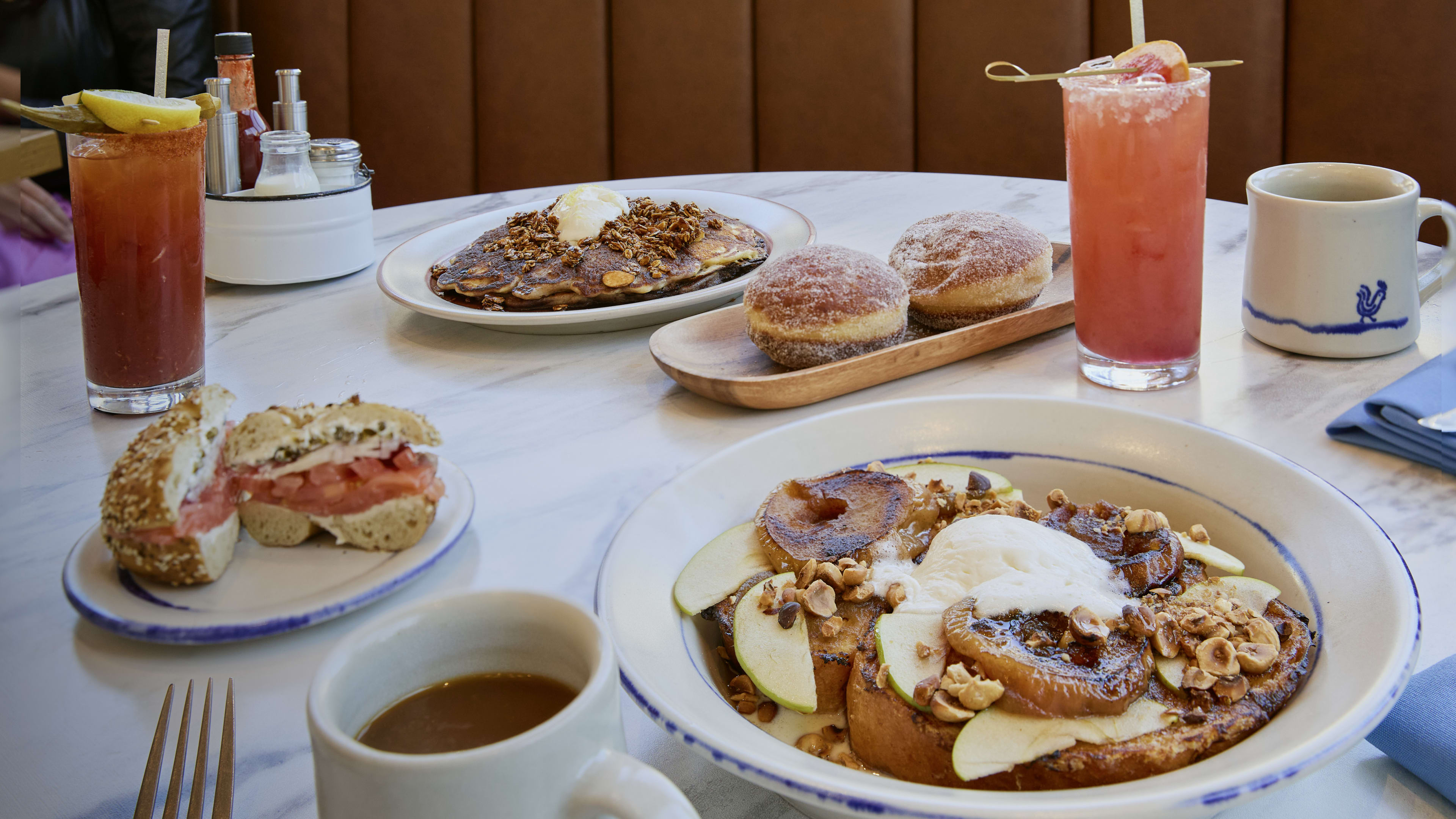 A spread of french toast, donuts, bagels, and pancakes at Early To Rise