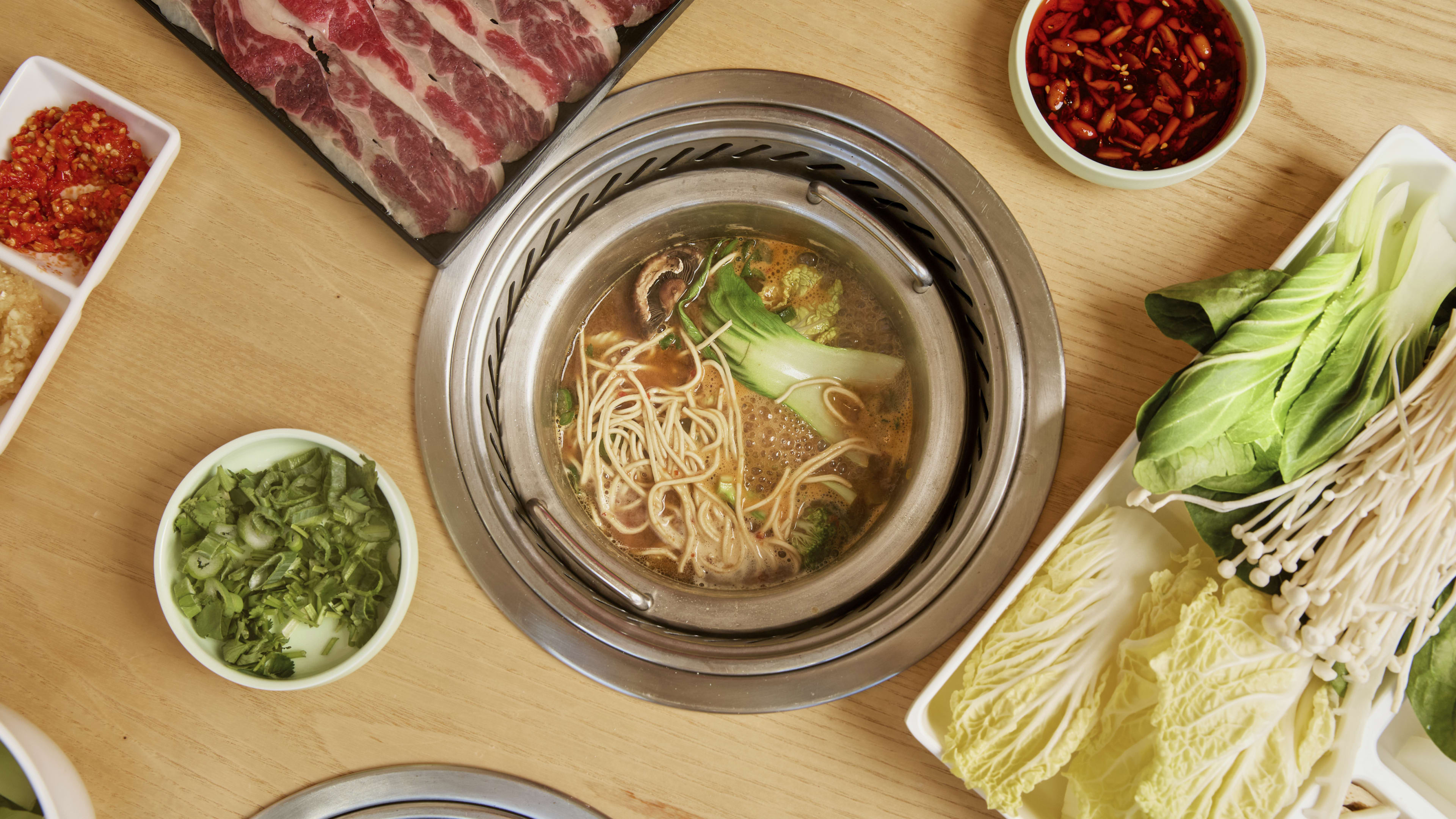 A hot pot with noodles at Mumu Hot Pot