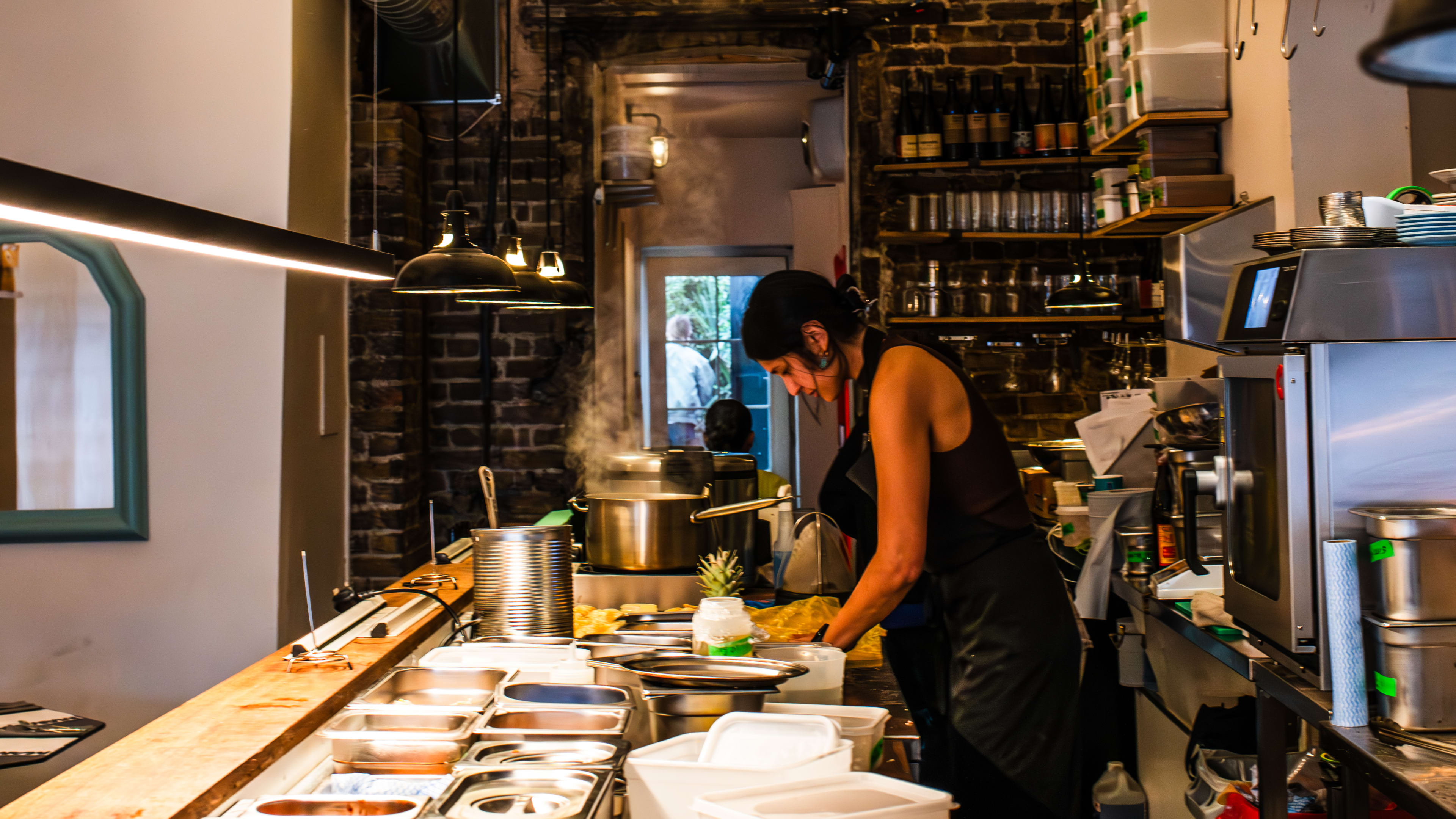 Head chef and owner Abby Lee of Mambow prepping in the open kitchen.