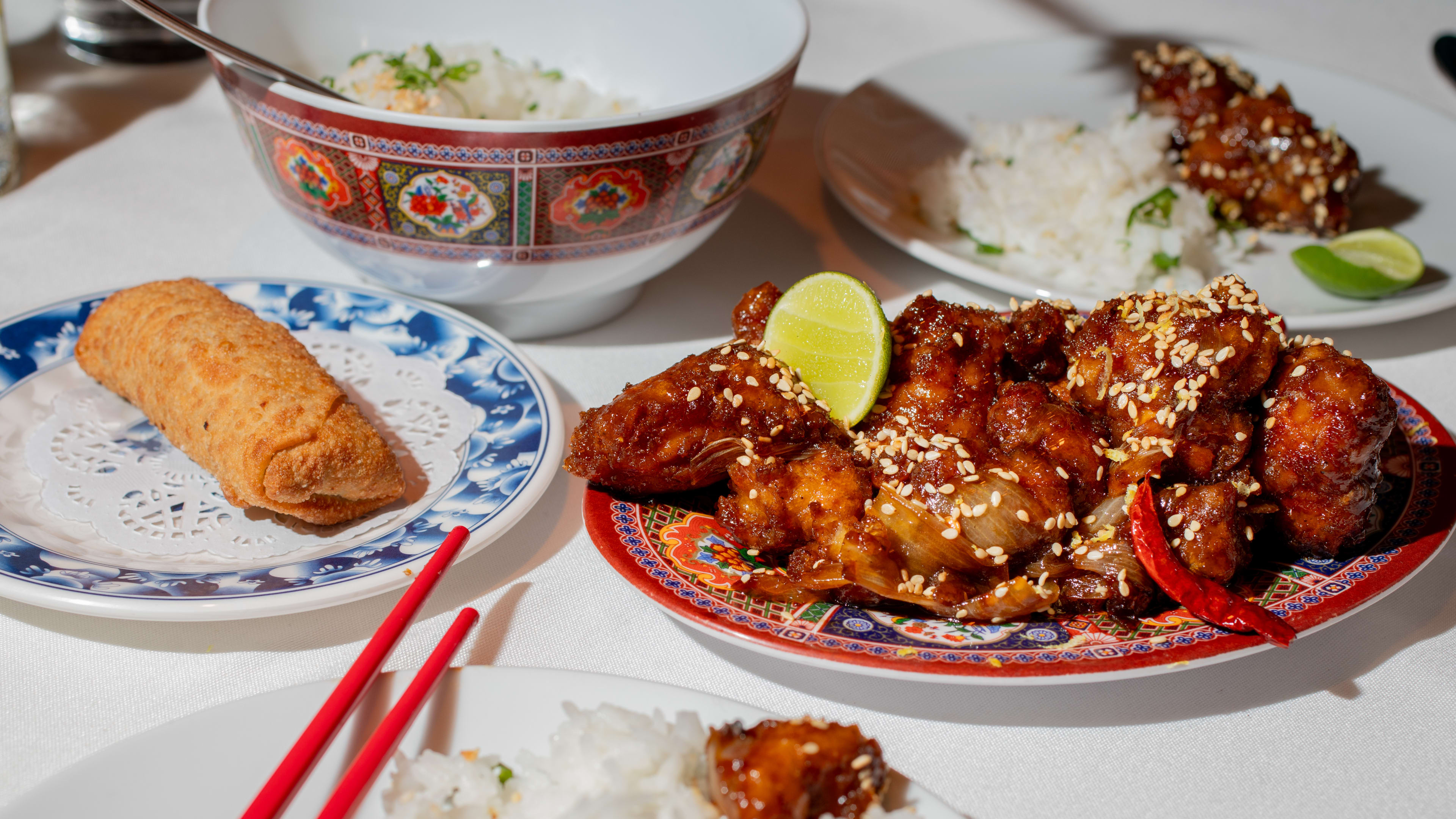 General chos chicken, an egg role, and other Chinese dishes on a table at Canton Mexical, a restaurant in Mexico City