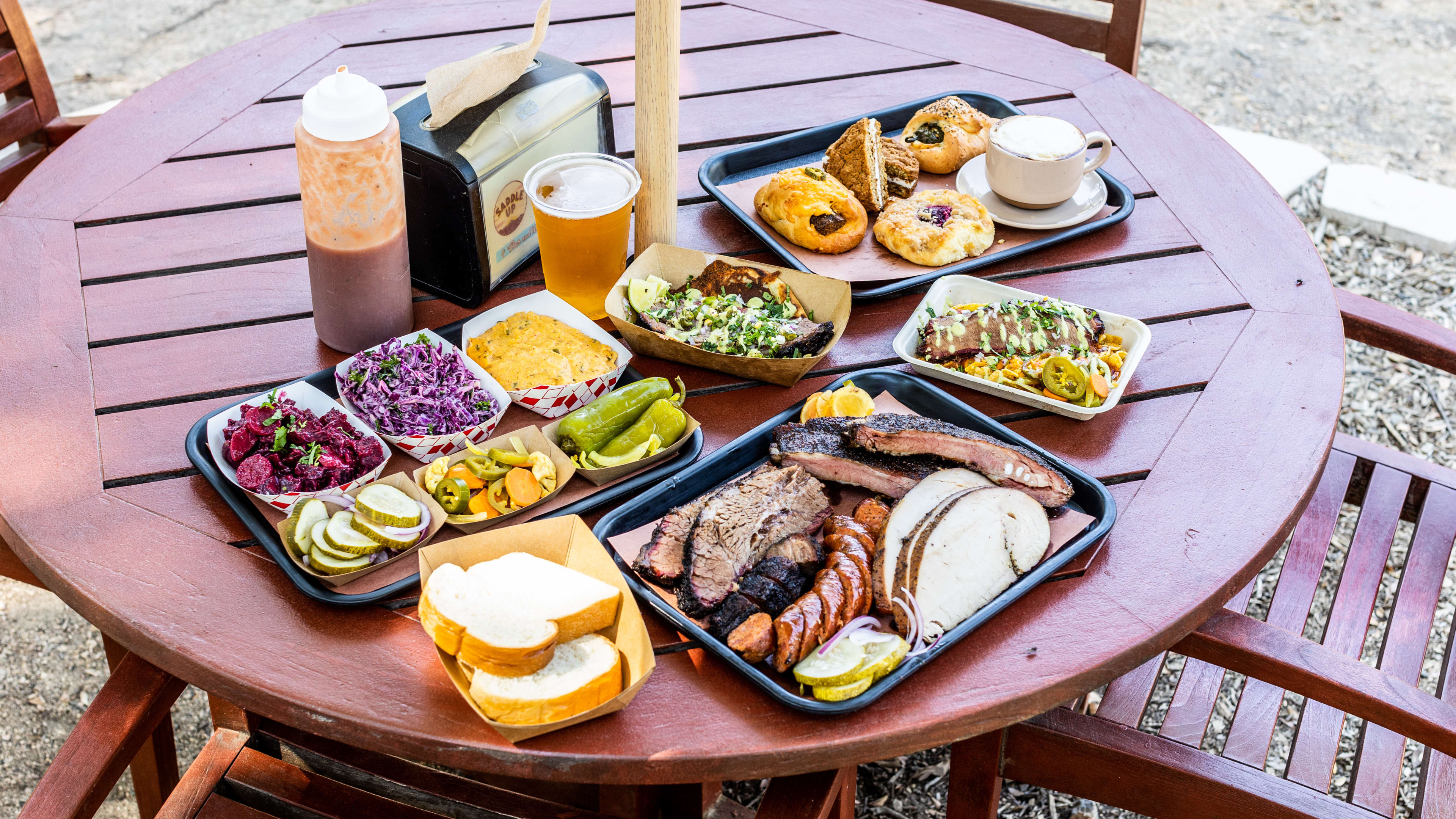 A spread of dishes from Micklethwait on a round picnic table.