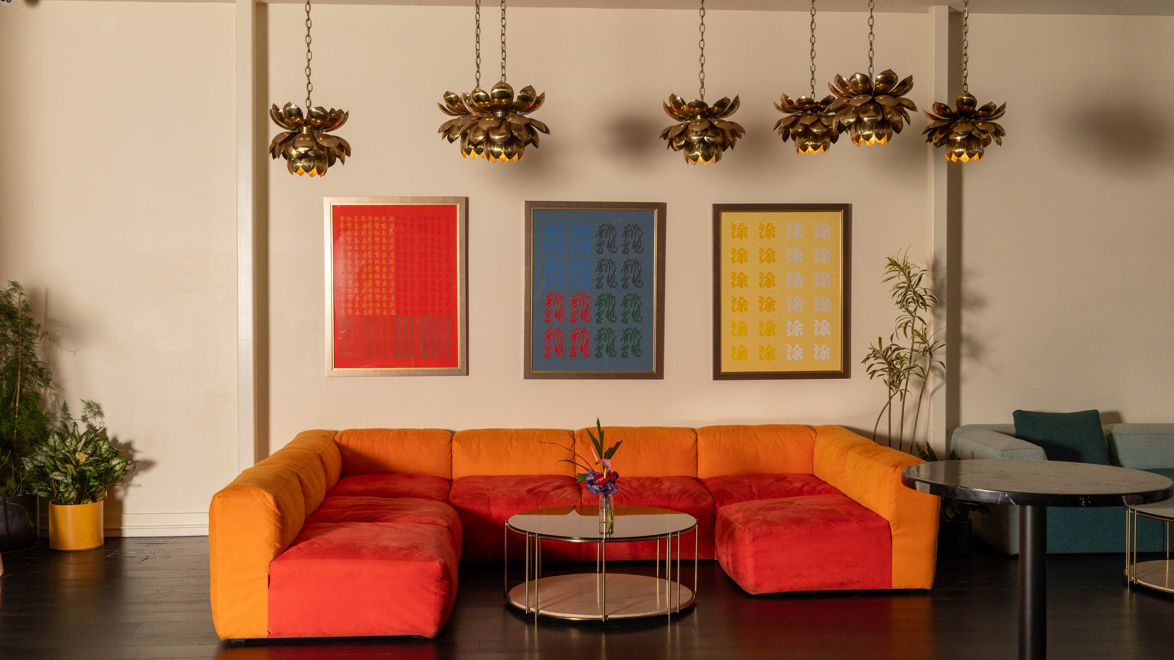 brightly colored modern sofa with table and colorful art on wall