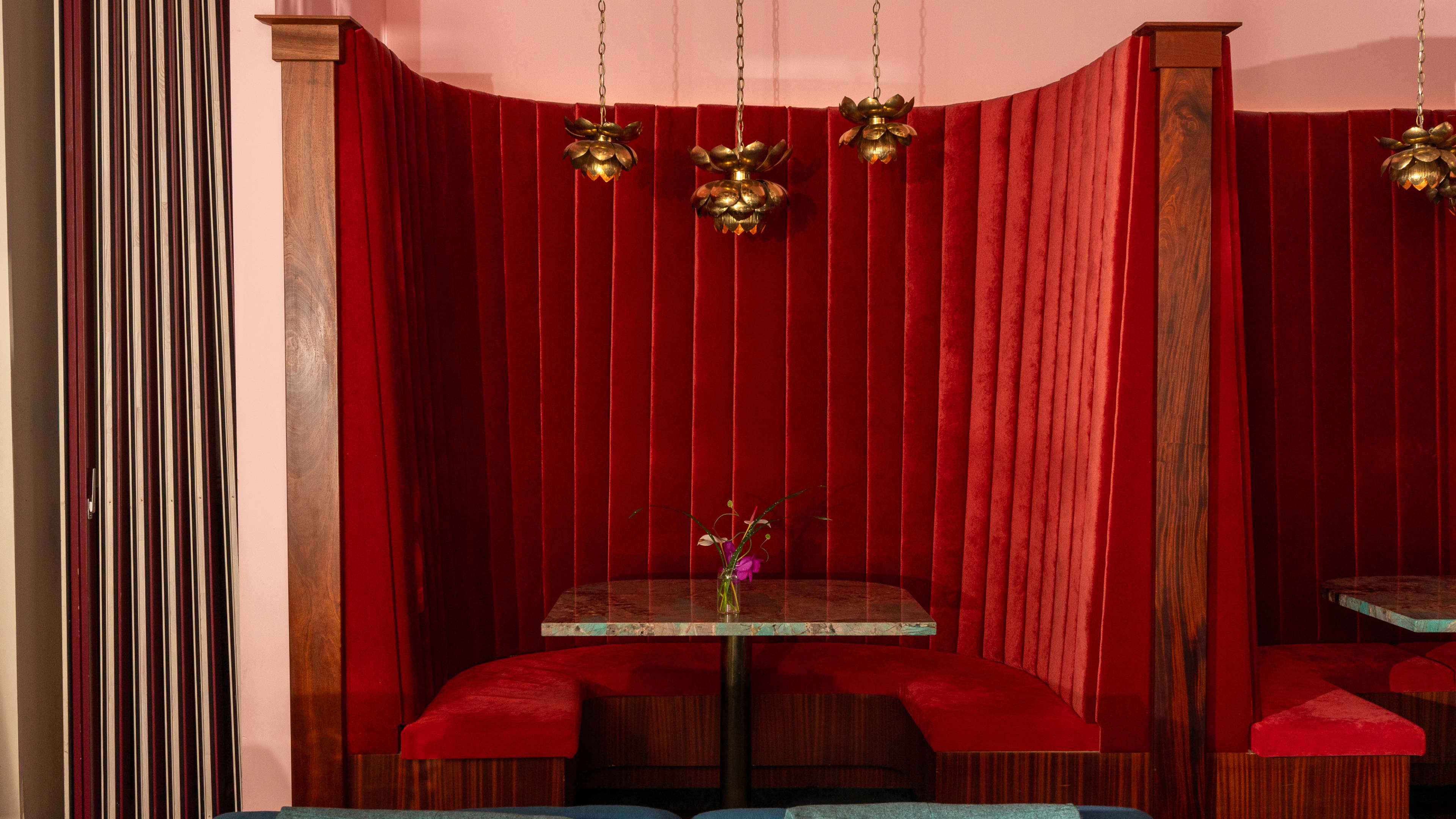 semicircle velvet booth with modern light fixtures and marble table