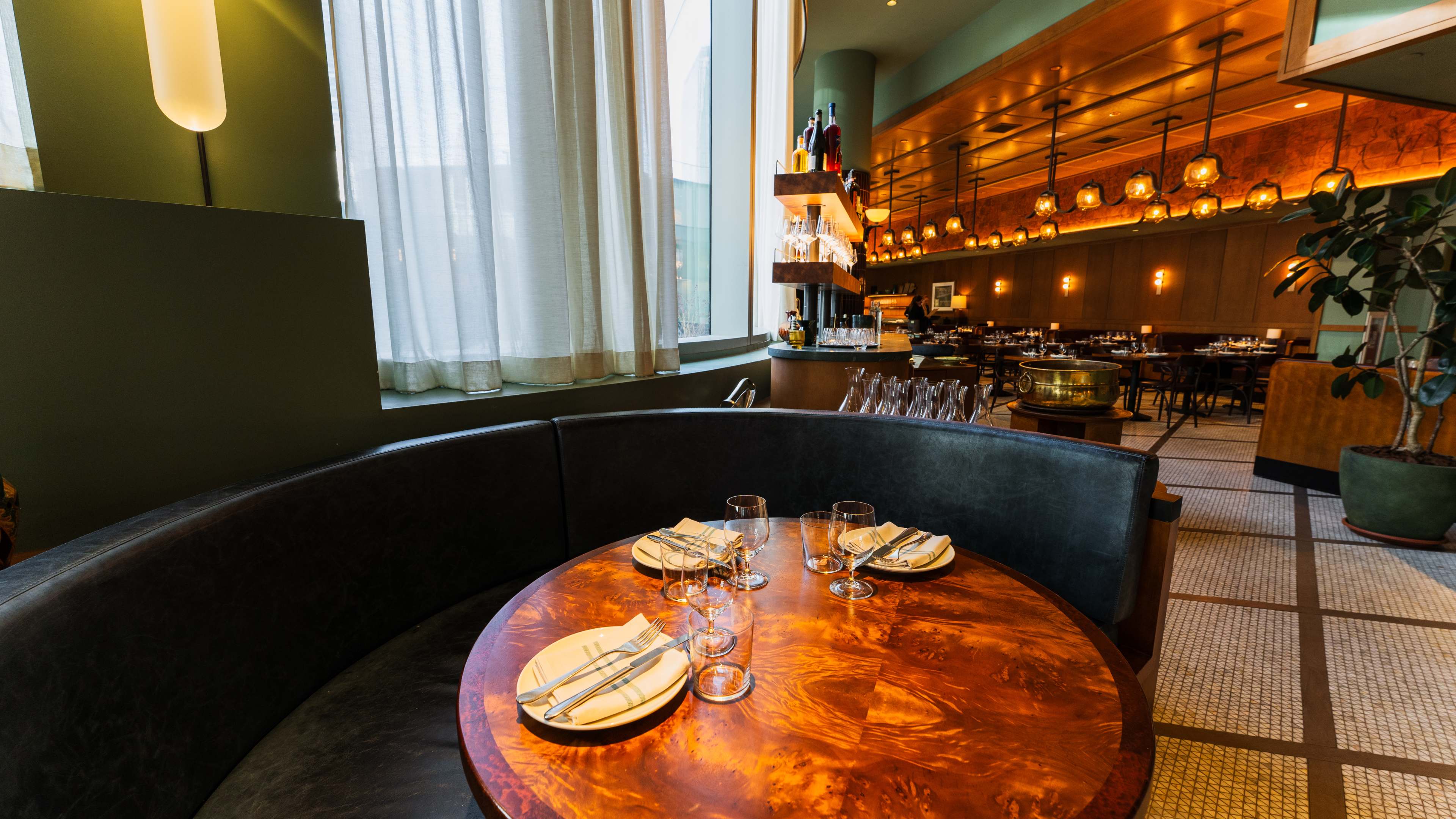 the interior of ci siamo, with a large banquette in frame