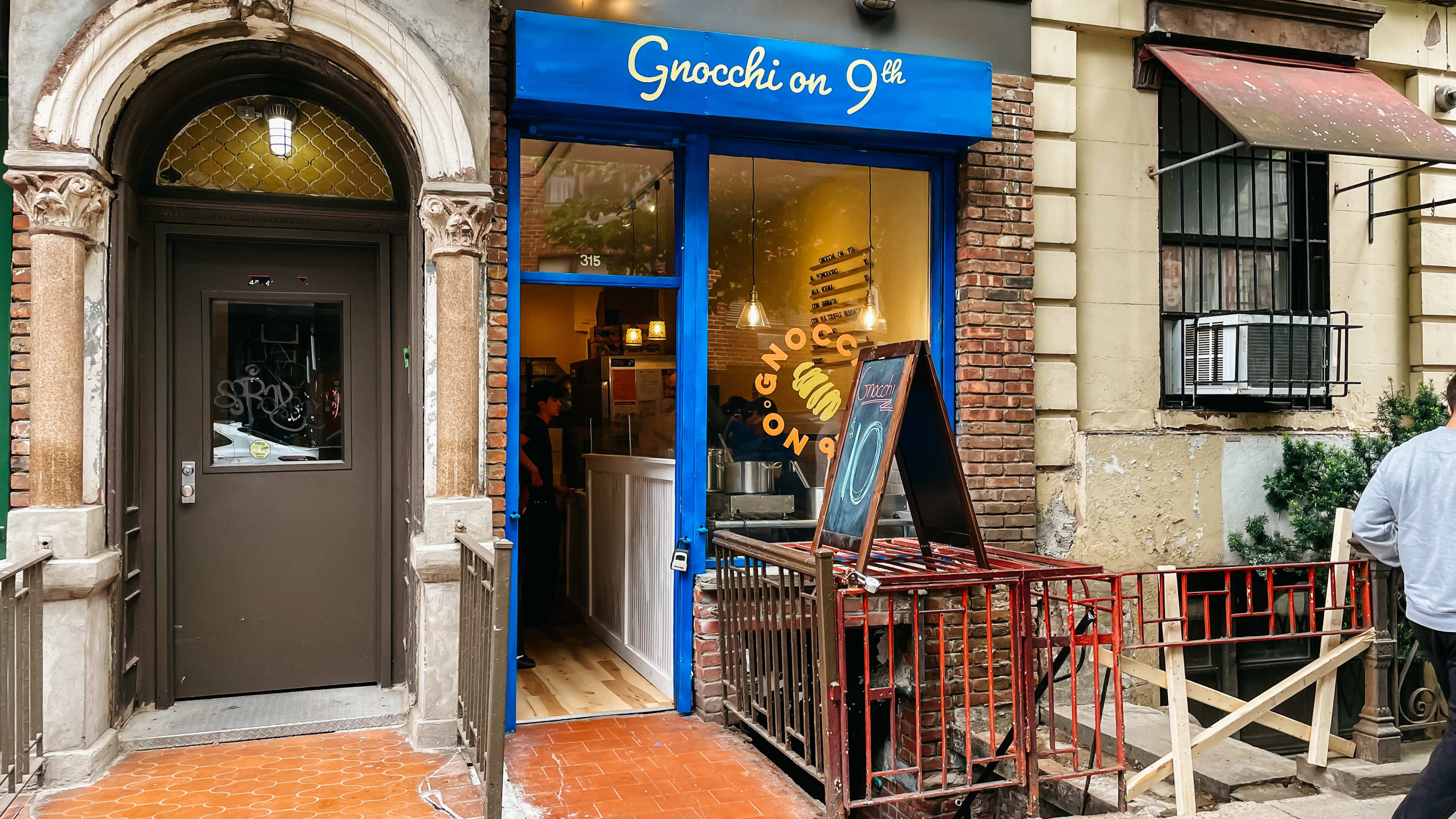 a blue storefront that says gnocchi on 9th