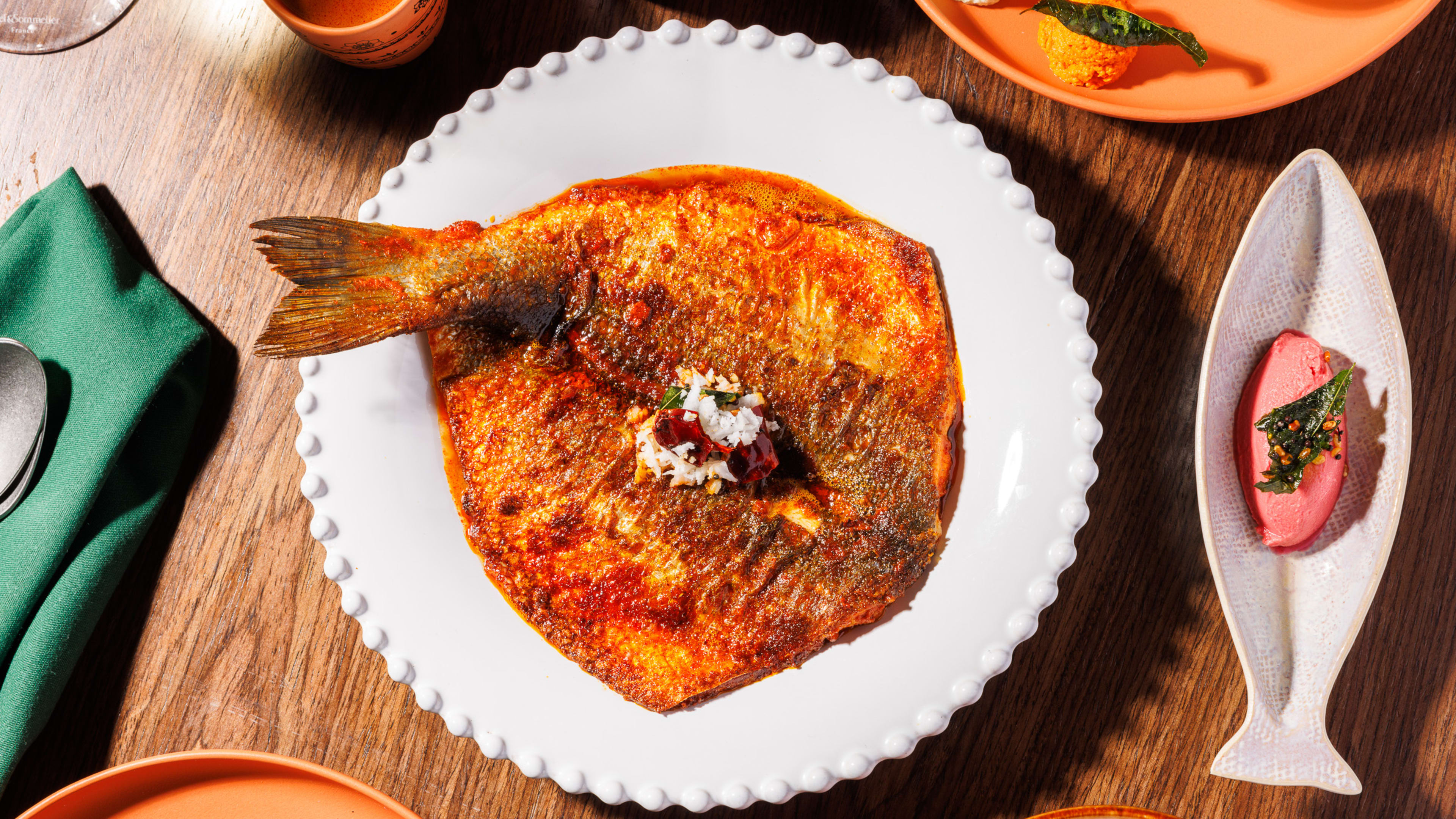 A thick curry topped with a whole butterflied branzino.