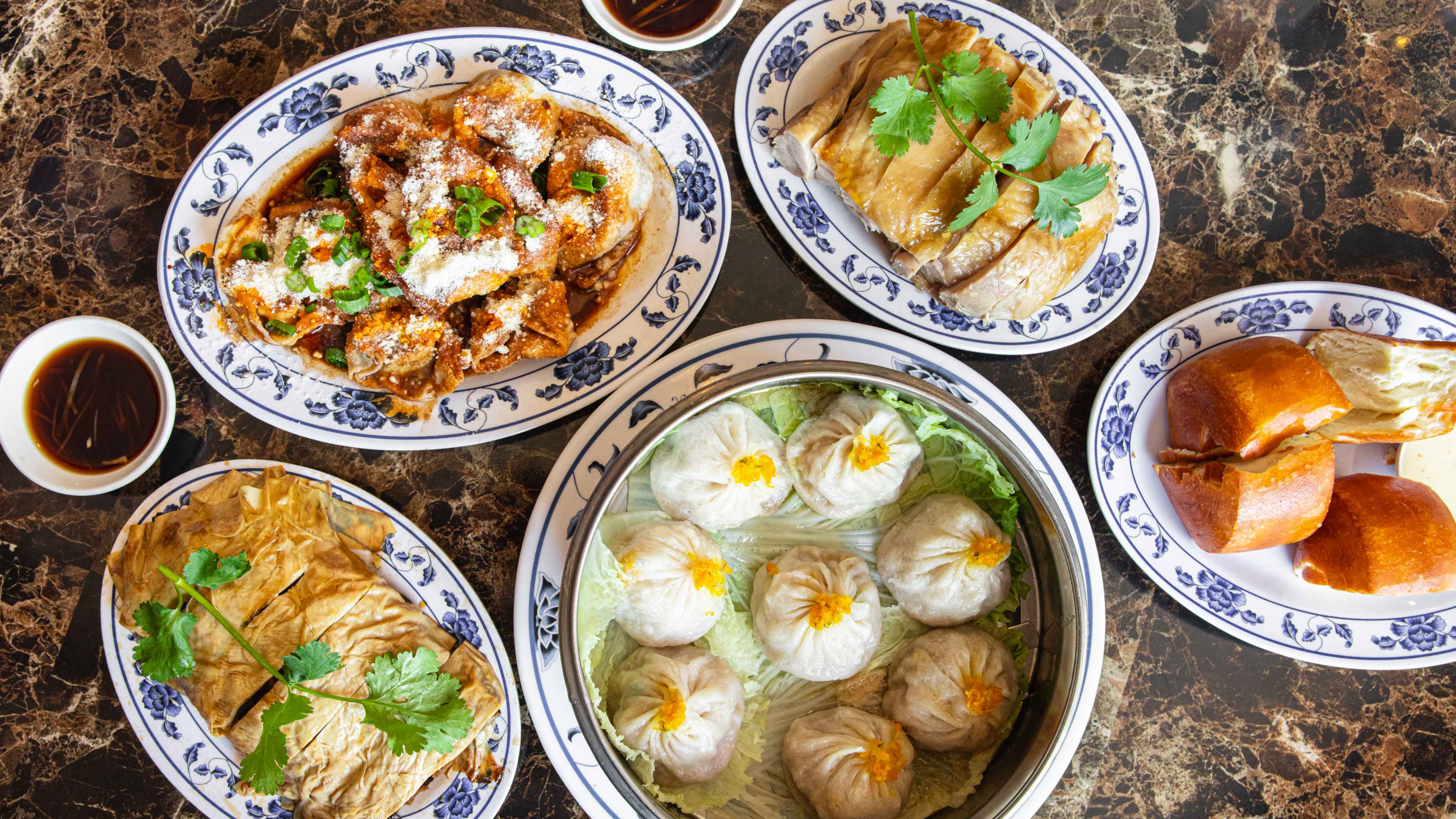 Plates of food on a marble table.