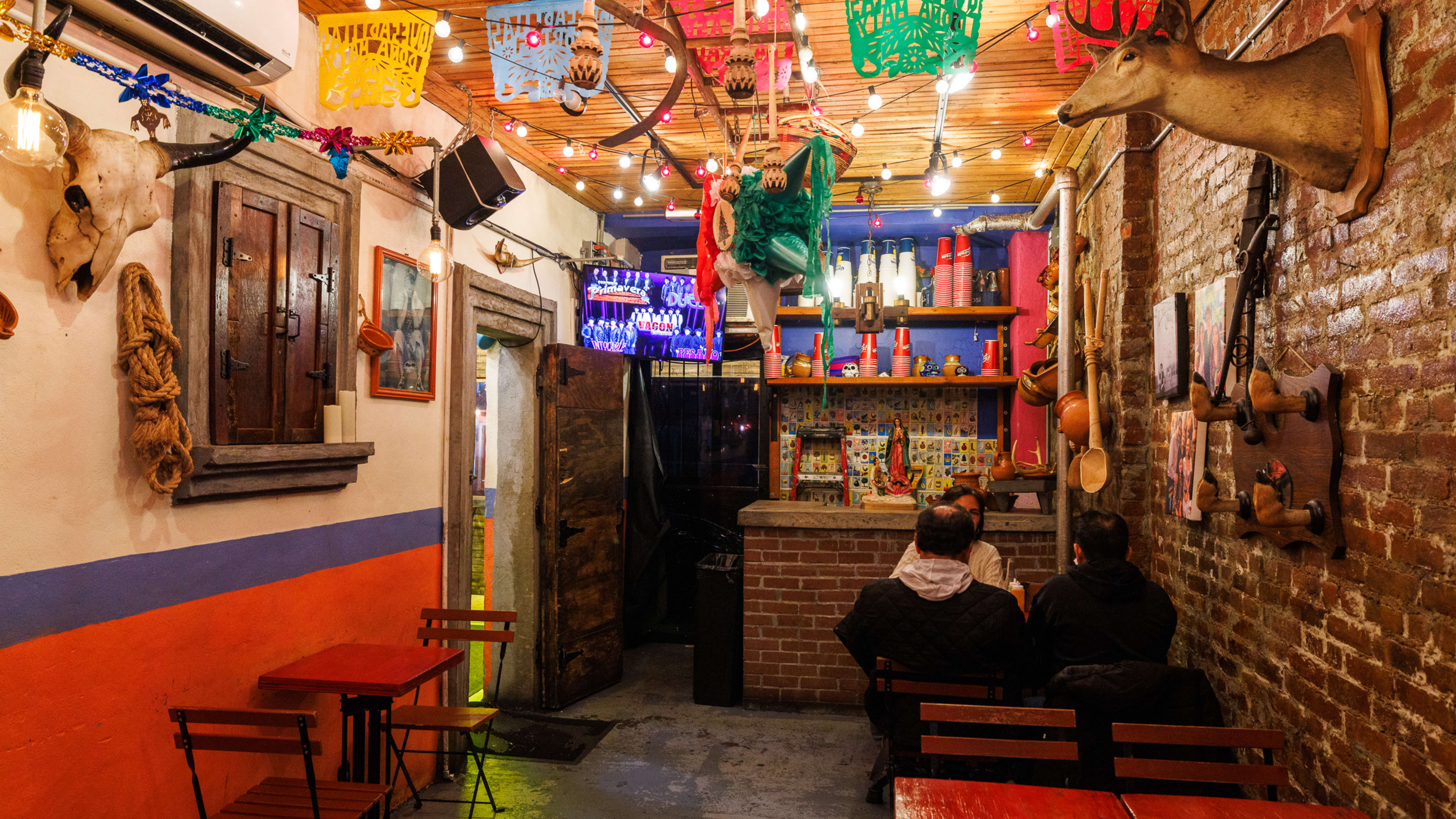 The interior of Quesadillas Doña Maty with people sitting at a table.