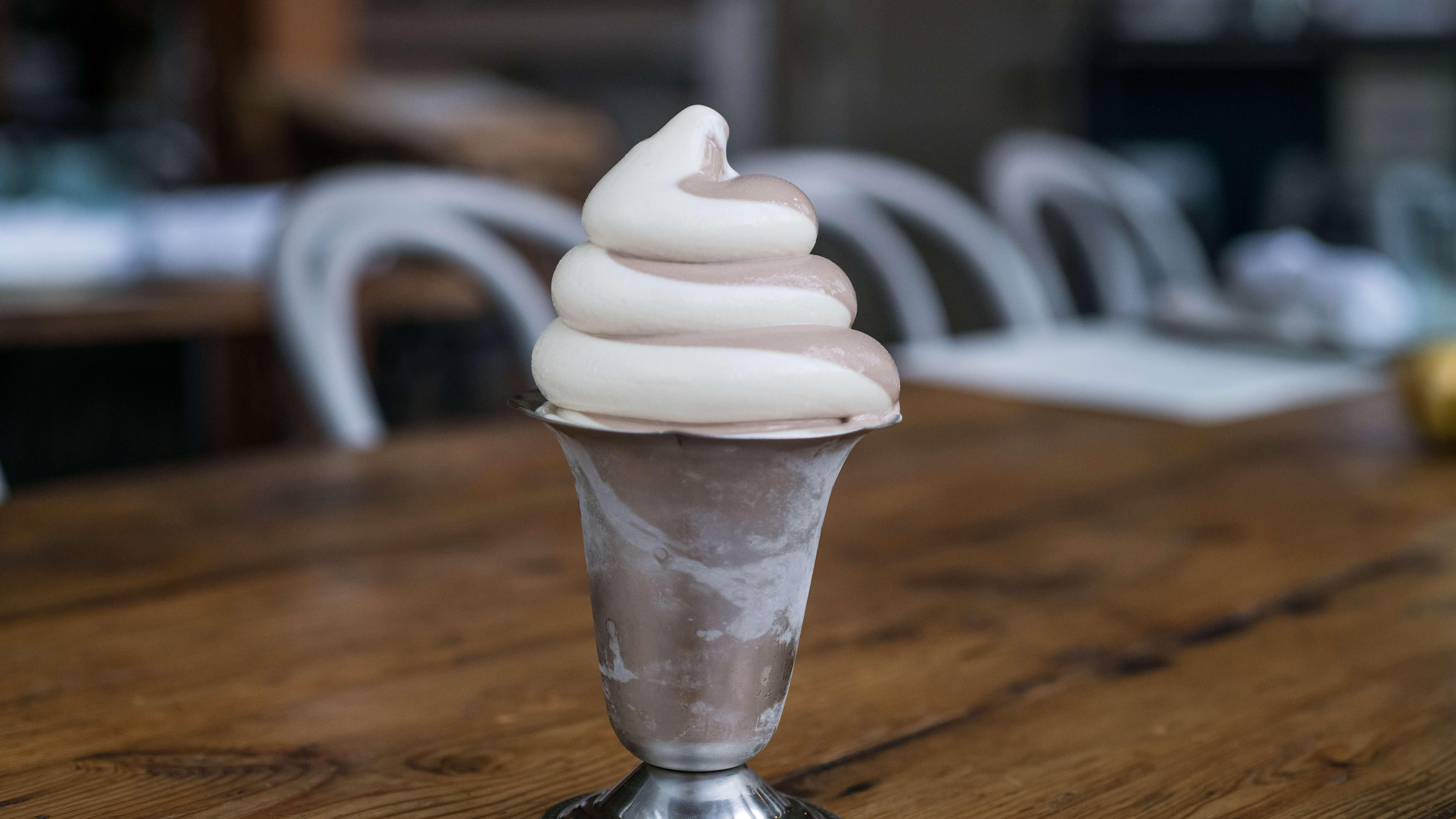 Tin cup filled with vanilla/chocolate swirl soft serve.