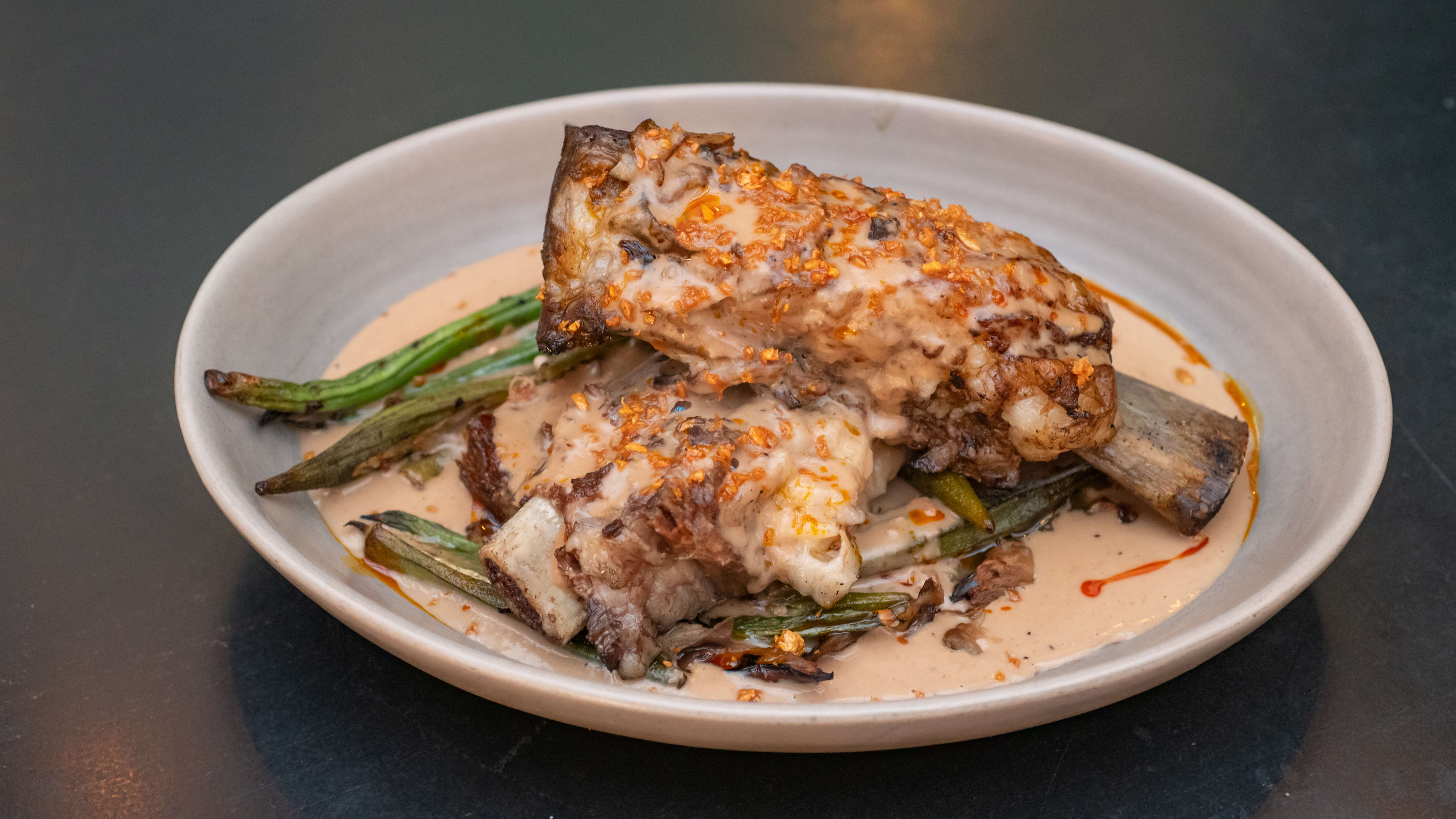 Short rib with creamy sauce and charred scallions.