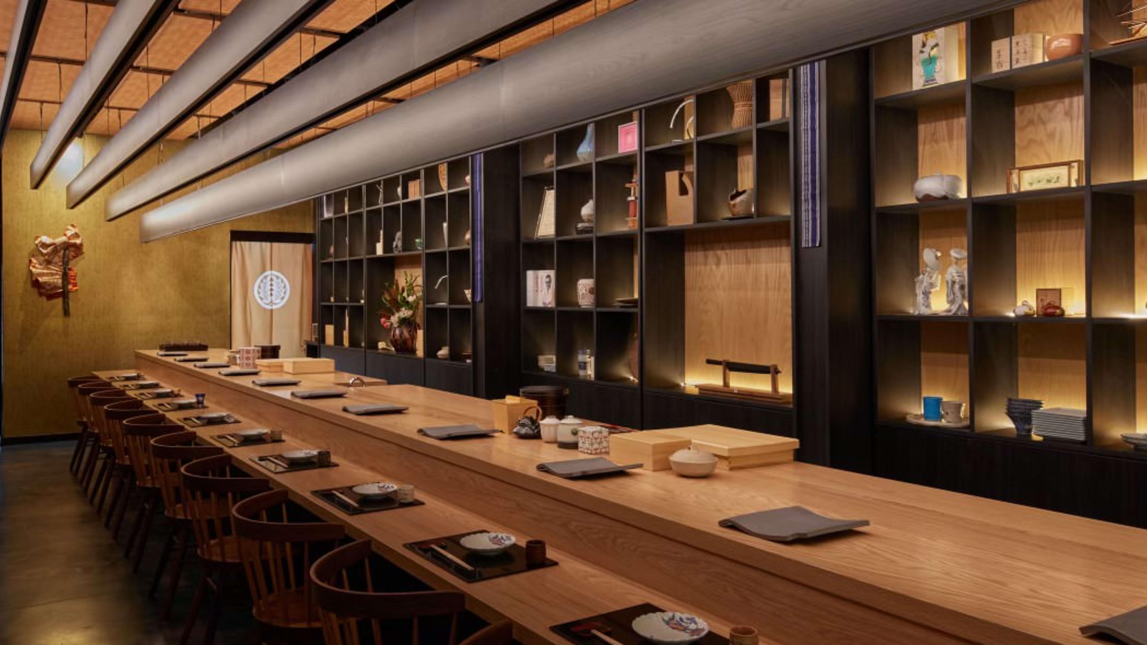 A narrow dining room with a wooden counter.