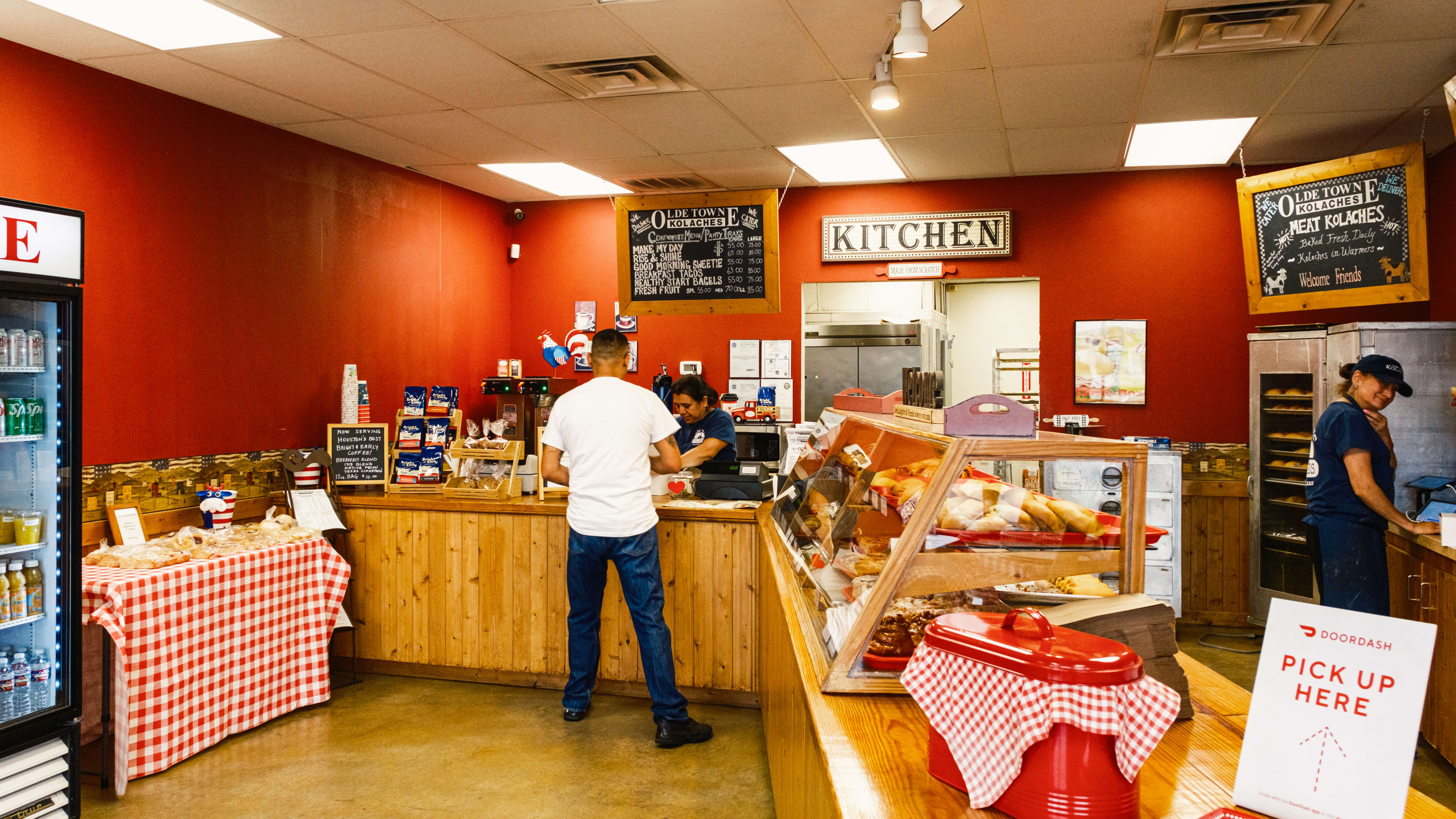 A person orders at the wooden counter at Olde Towne Kolaches.