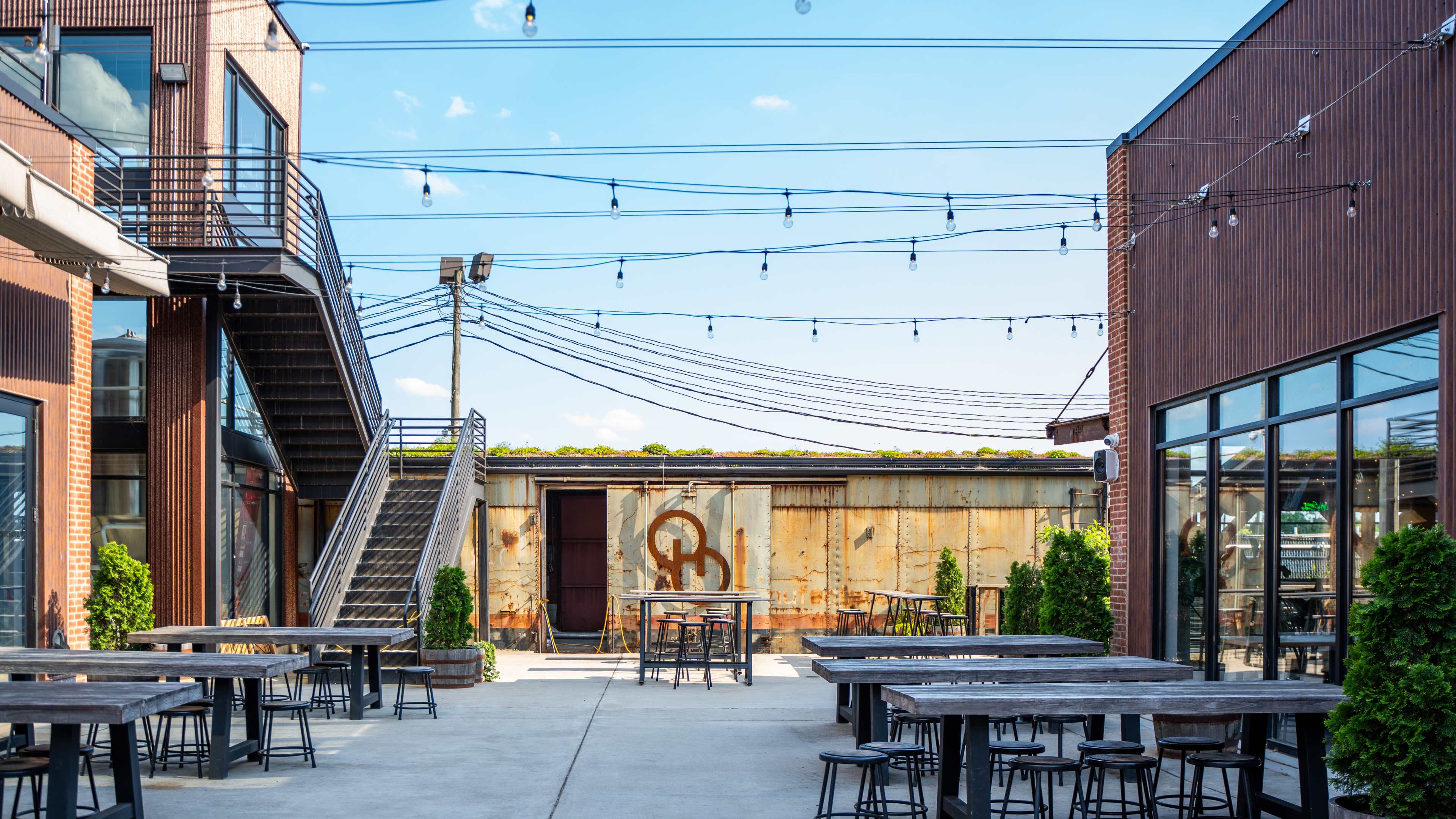 courtyard of brewery with string lights and lots of seating